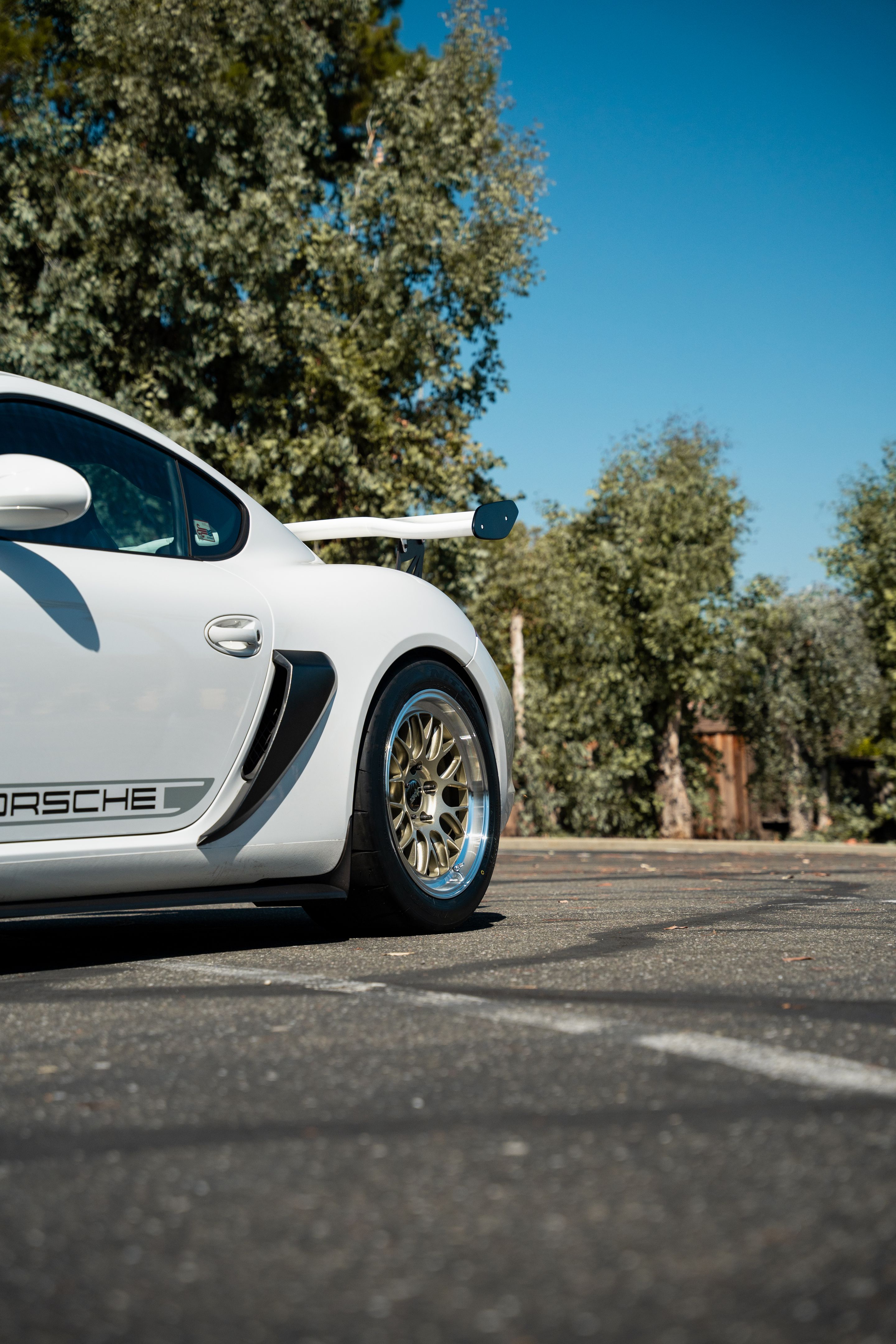 White Porsche 987 Cayman Base with 18" ML-10RT Apex wheels in Machined Lip Gloss Motorsport Gold
