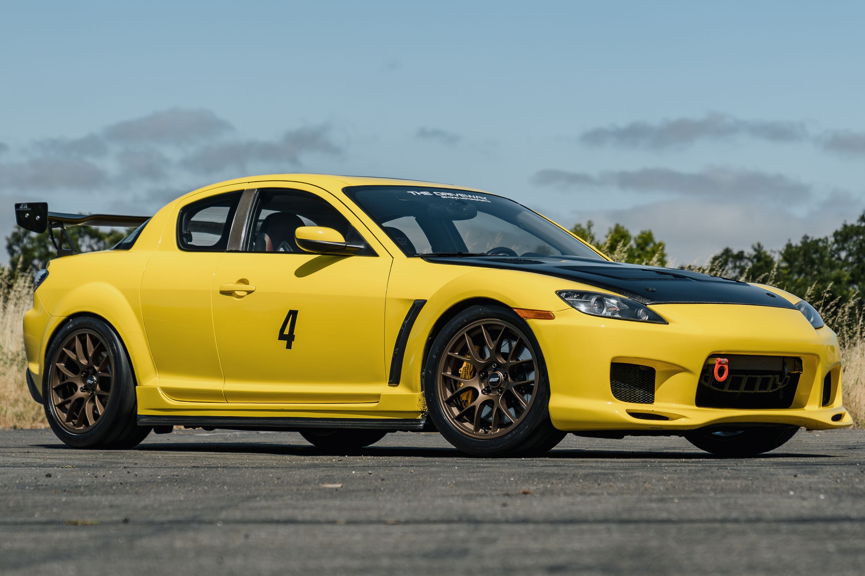 Yellow Mazda RX-8 with 18" EC-7 Apex wheels in Satin Bronze