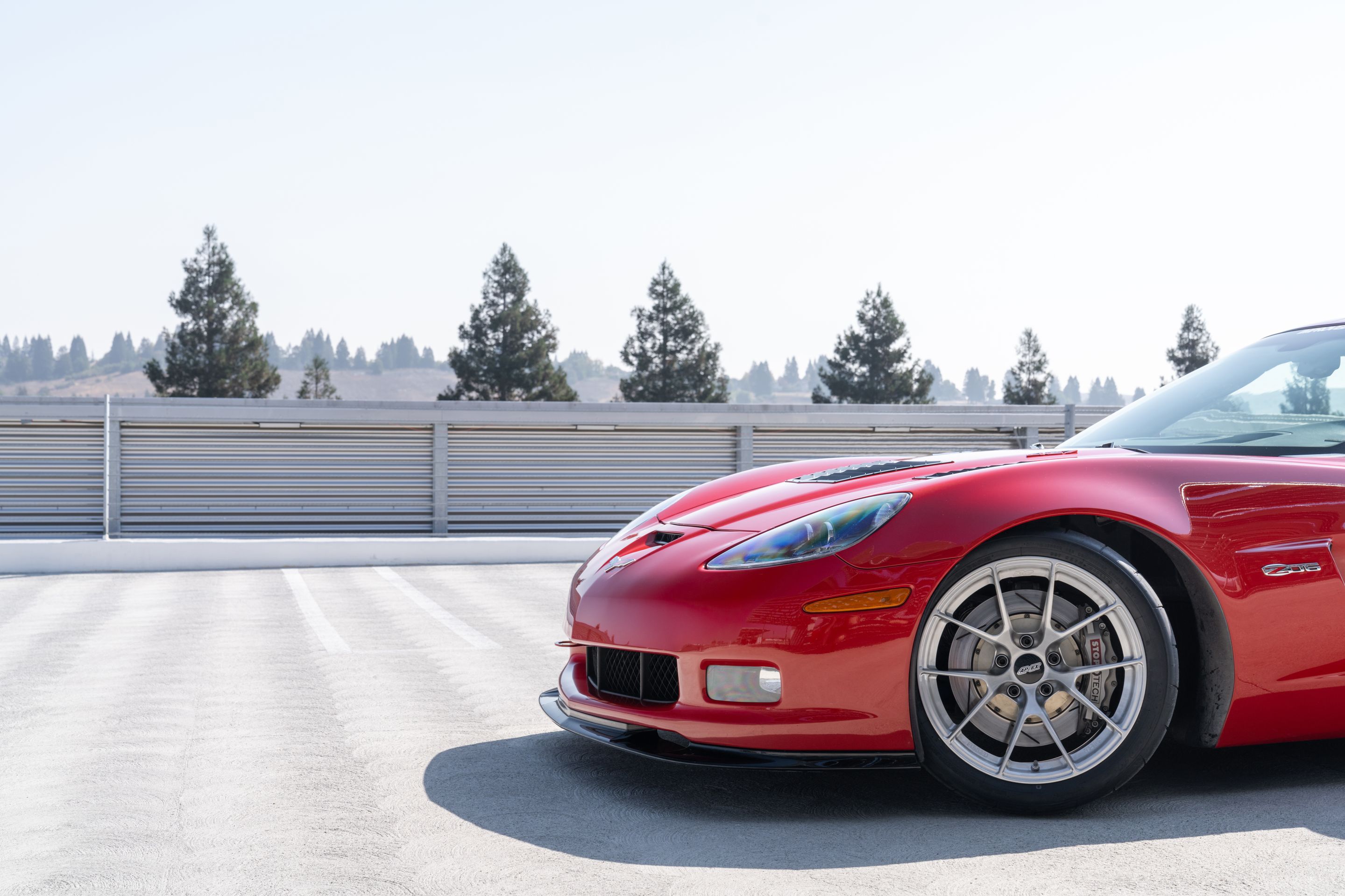 Red Chevrolet C6 Corvette Z06 with 18" VS-5RS Apex wheels in Brushed Clear
