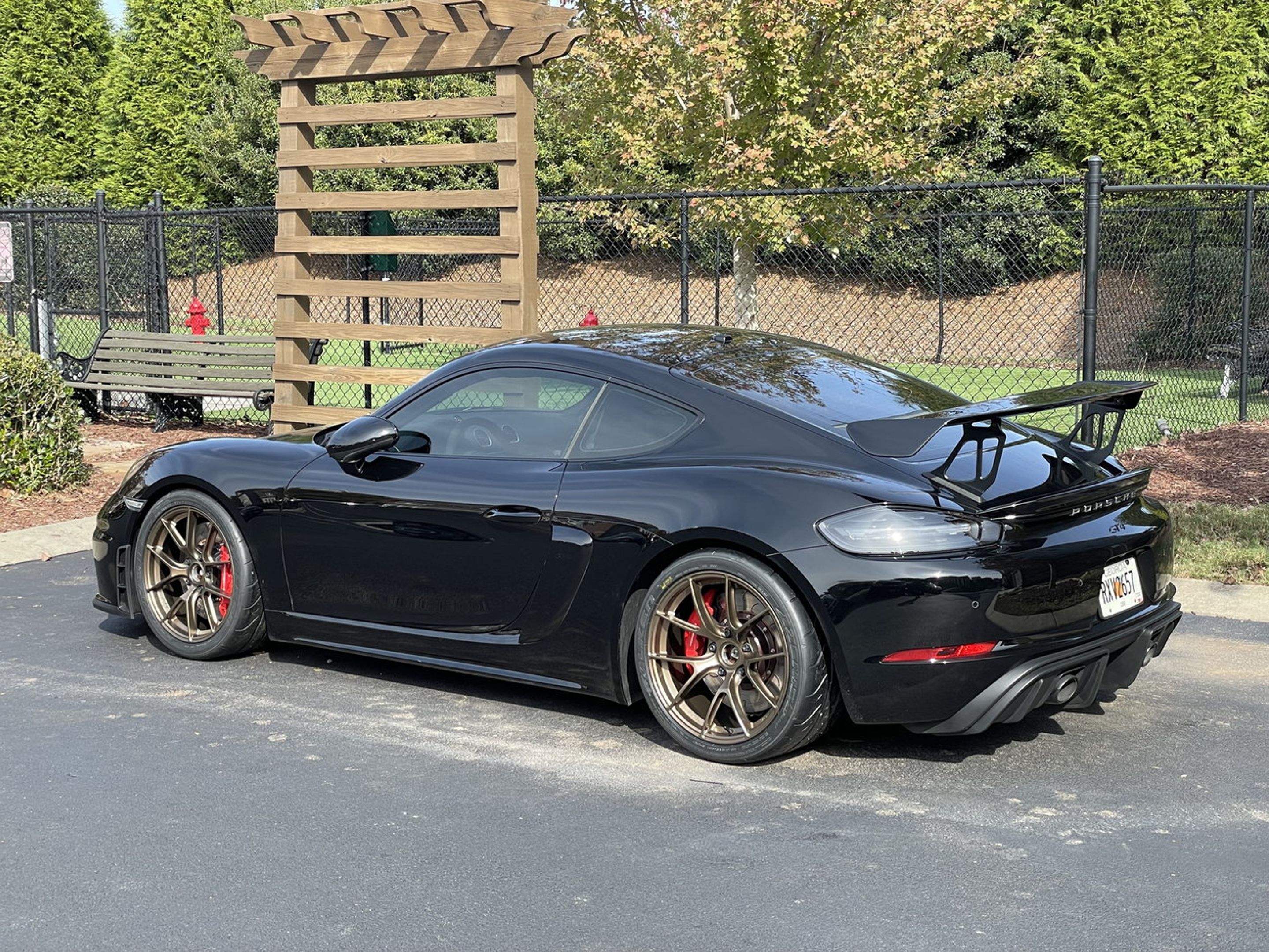 Black Porsche 718 Cayman GT4 with 19" VS-5RS Apex wheels in Satin Bronze