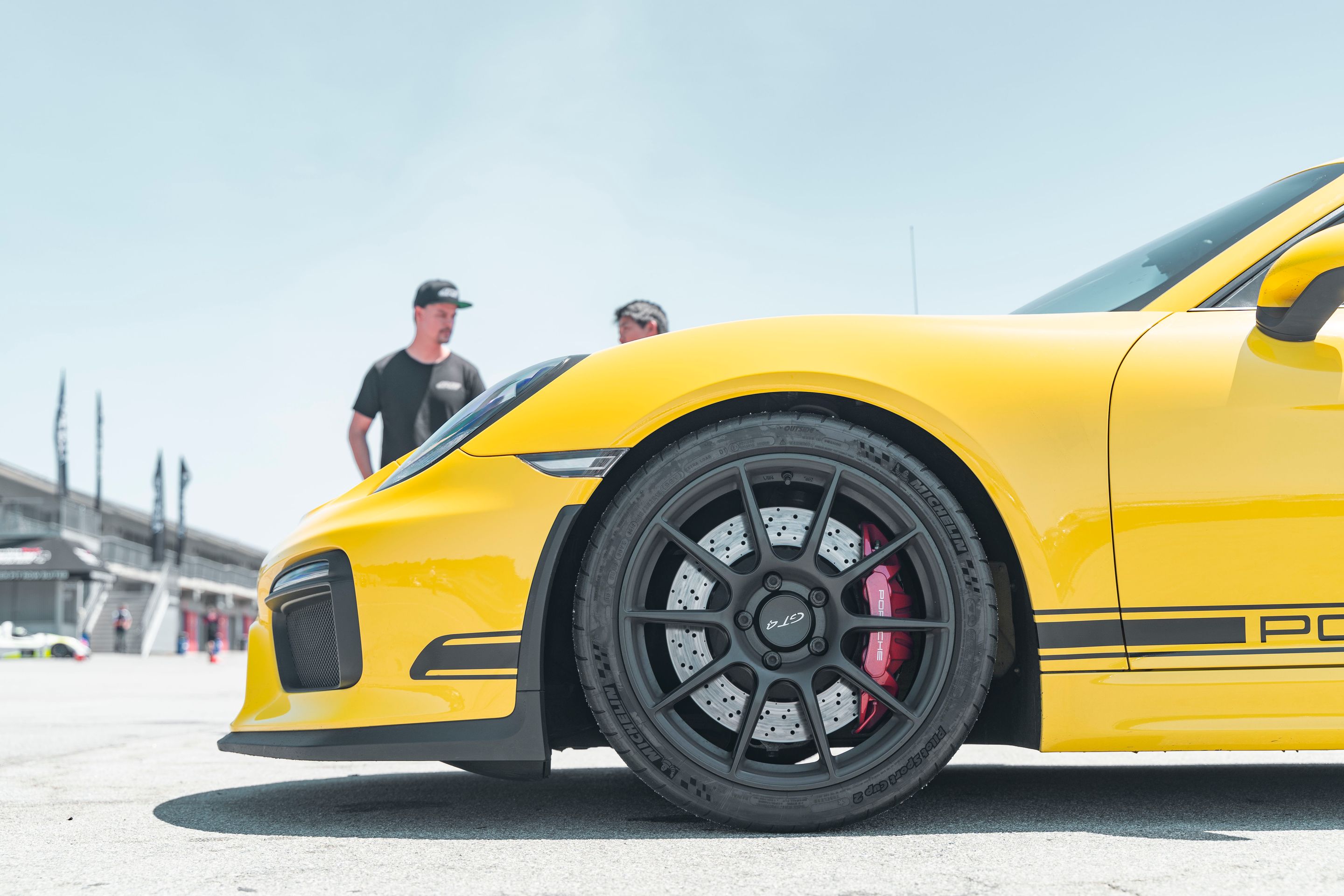 Yellow Porsche 981 Cayman GT4 with 19" SM-10 Apex wheels in Satin Black