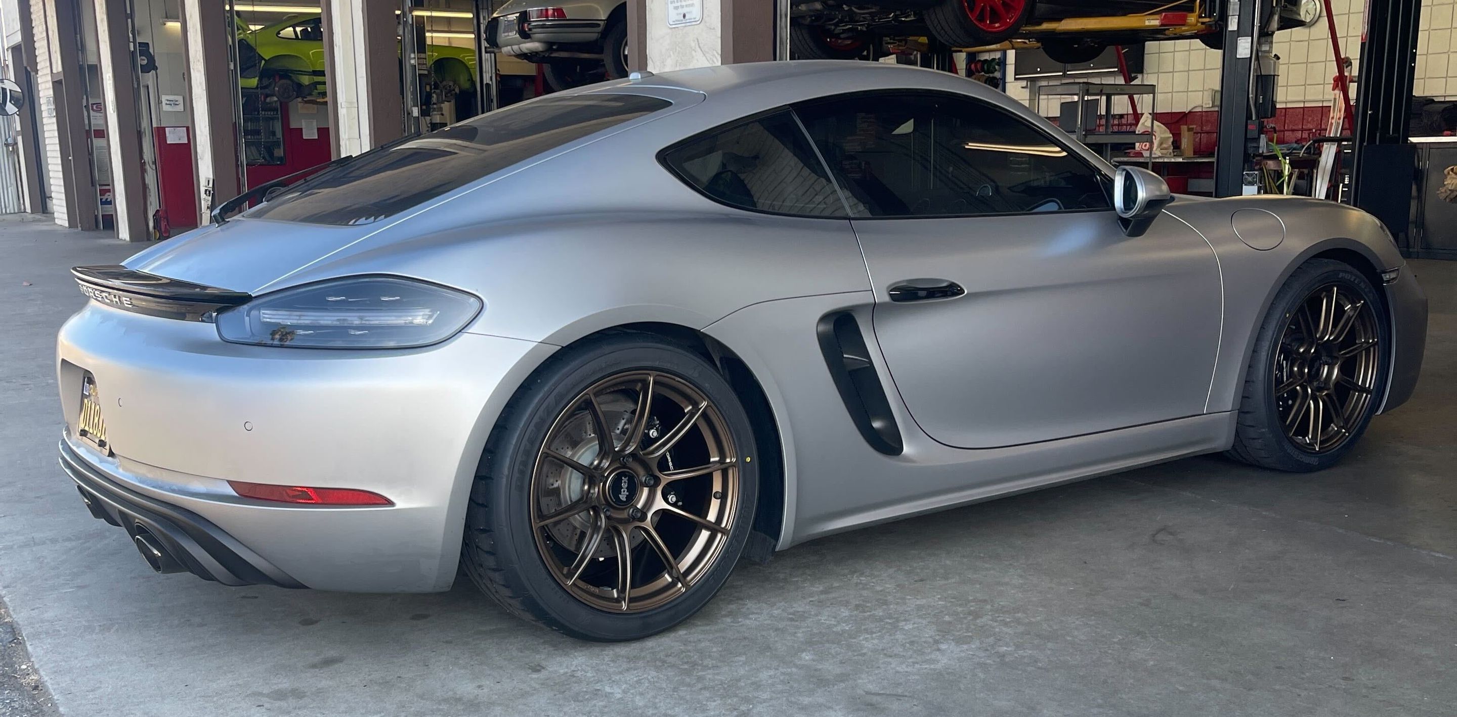 Silver Porsche 718 Cayman GTS 4.0L with 19" SM-10RS Apex wheels in Satin Bronze