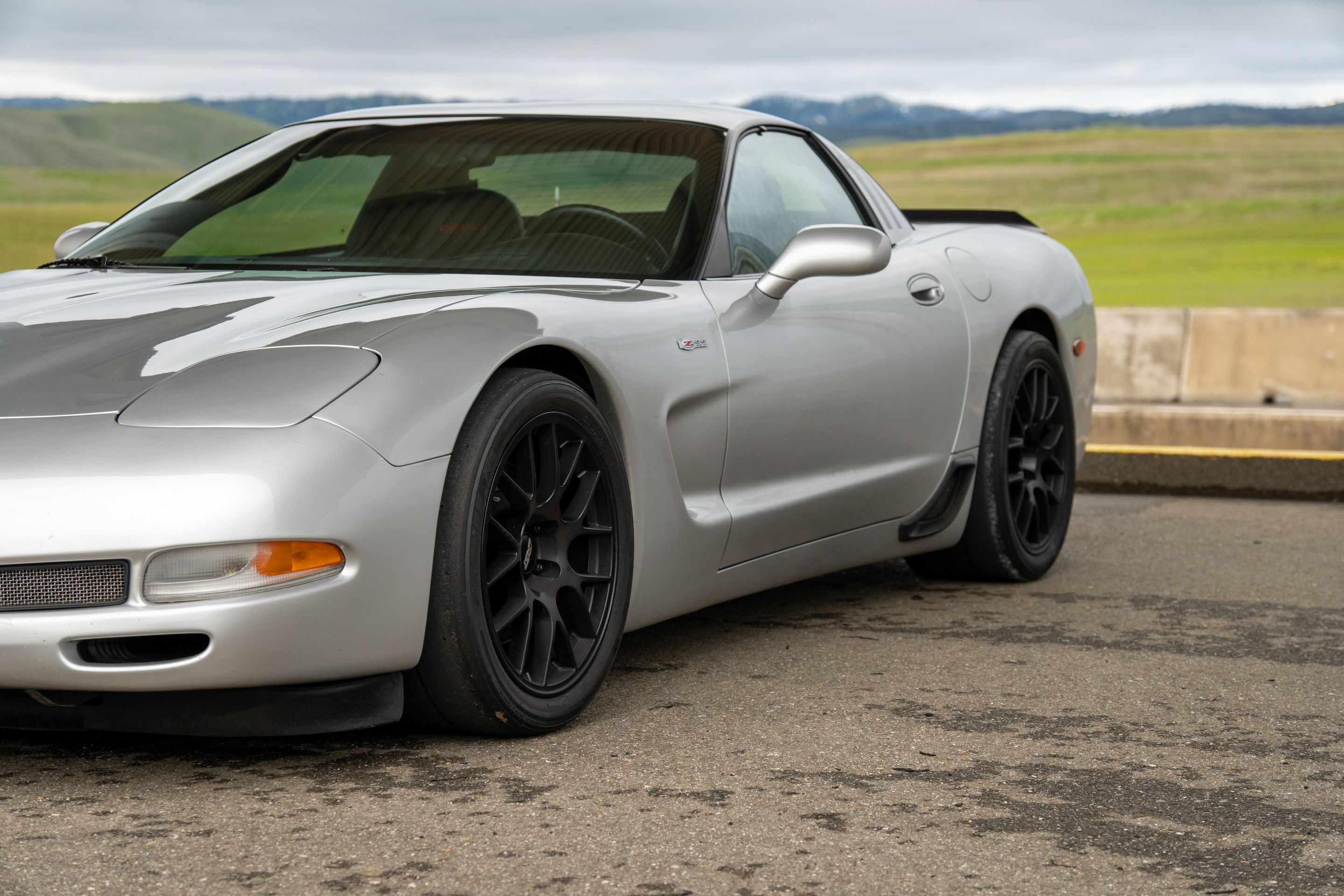 Silver Chevrolet C5 Corvette Z06 with 18" EC-7 Apex wheels in Satin Black