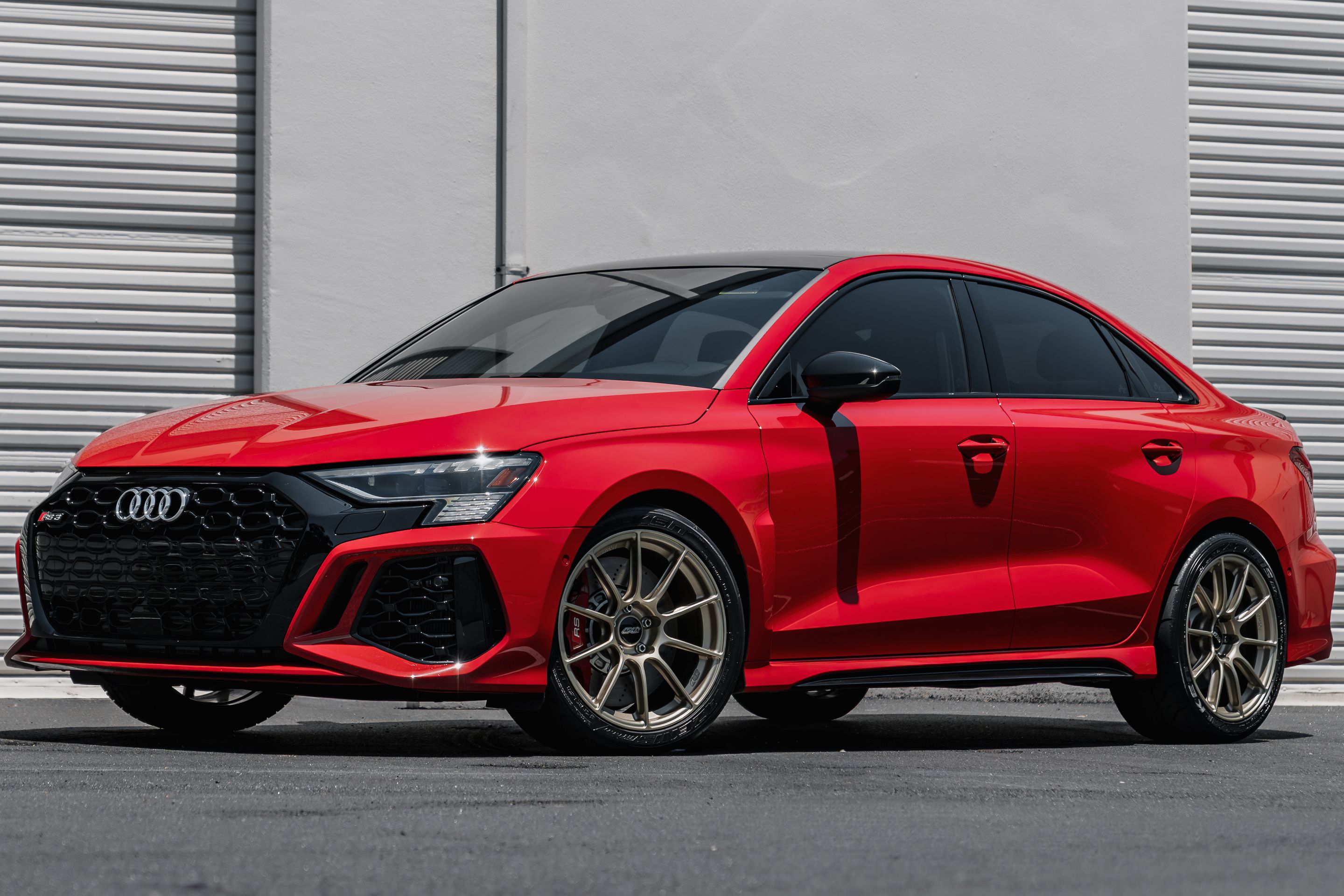 Red Audi 8Y RS 3 with 18" SM-10RS Apex wheels in Motorsport Gold