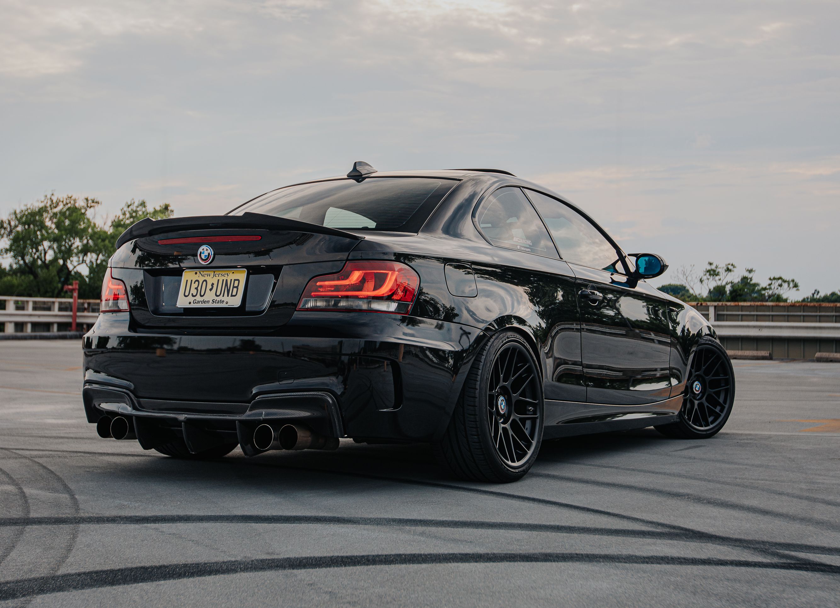 Black BMW E82 1M with 18" ARC-8 Apex wheels in Satin Black