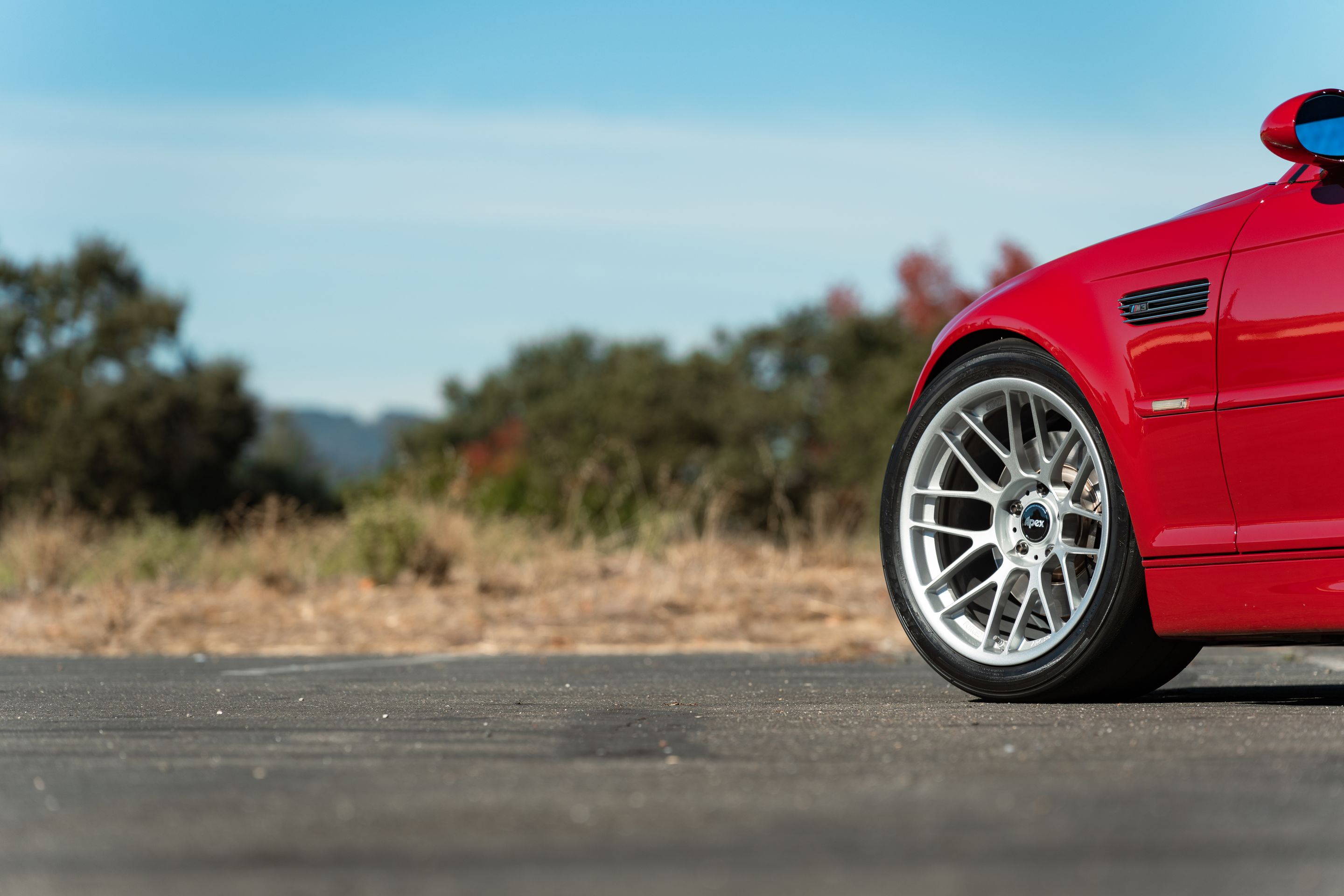 Red BMW E46 M3 with 18" ARC-8RT Apex wheels in Race Silver
