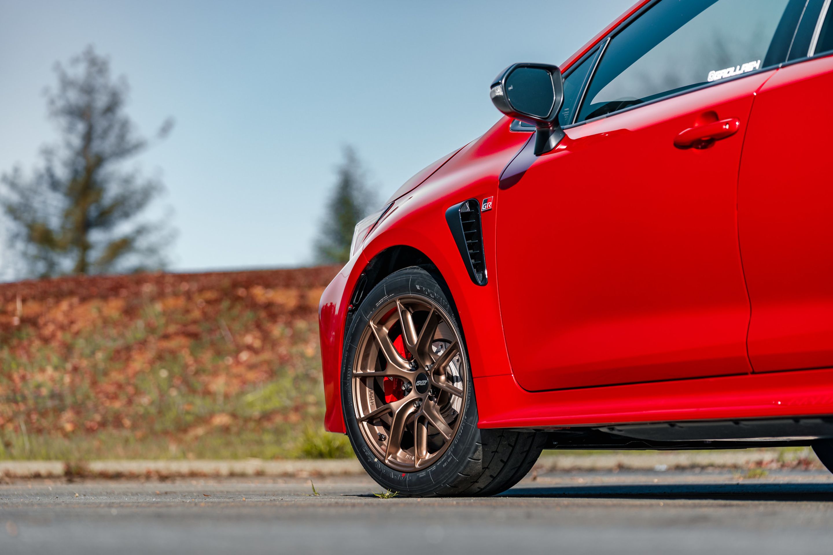 Red Toyota GR Corolla with 17" VS-5RS Apex wheels in Satin Bronze