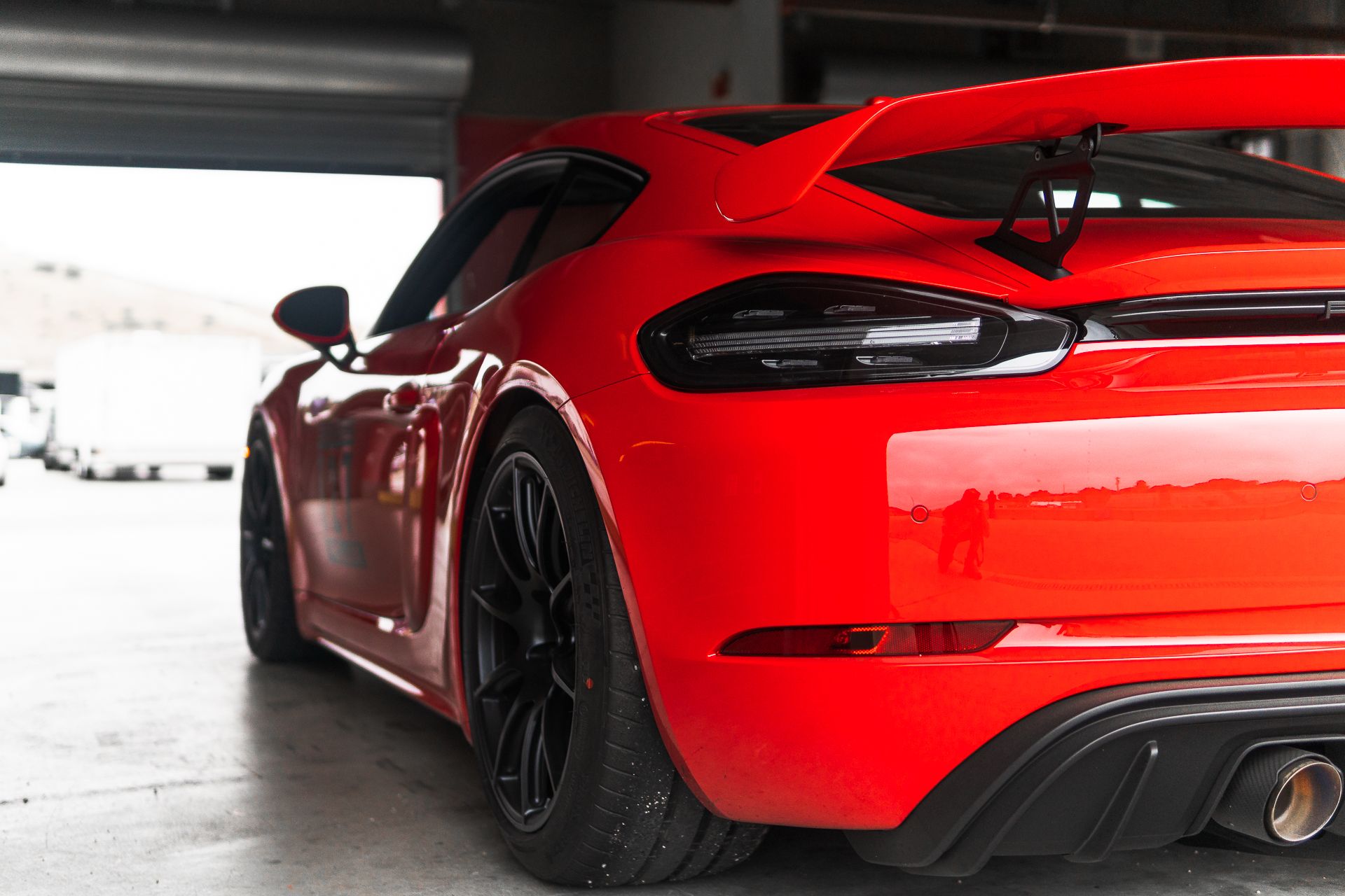 Red Porsche 718 Cayman GT4 with 19" SM-10 Apex wheels in Satin Black