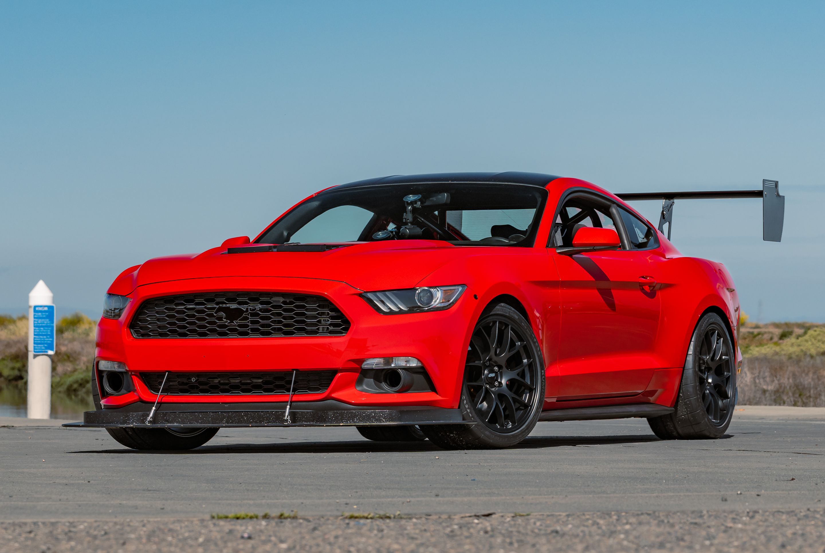 Red Ford S550 Mustang GT with 19" EC-7 Apex wheels in Satin Black
