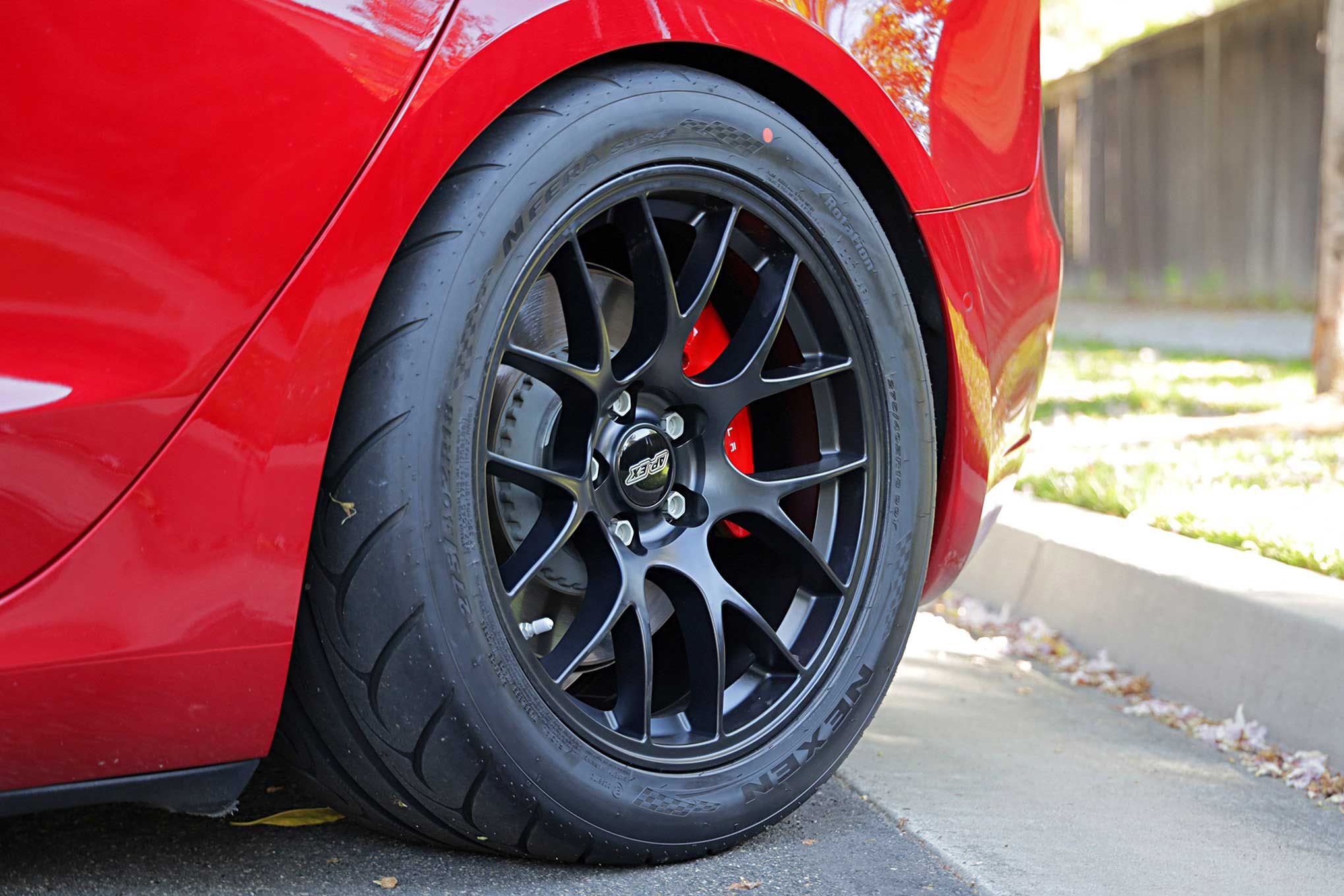 Red Tesla Model 3 with 18" EC-7 Apex wheels in Satin Black