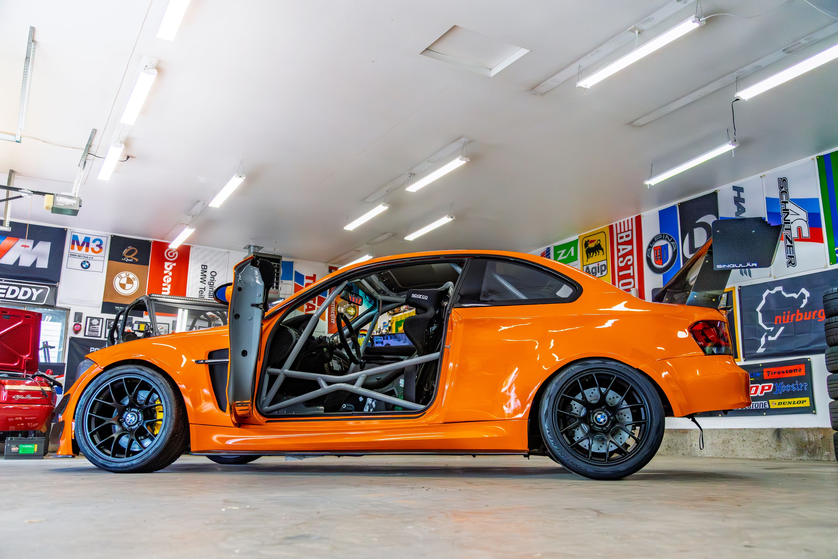 Orange BMW E82 1M with 18" EC-7 Apex wheels in Satin Black