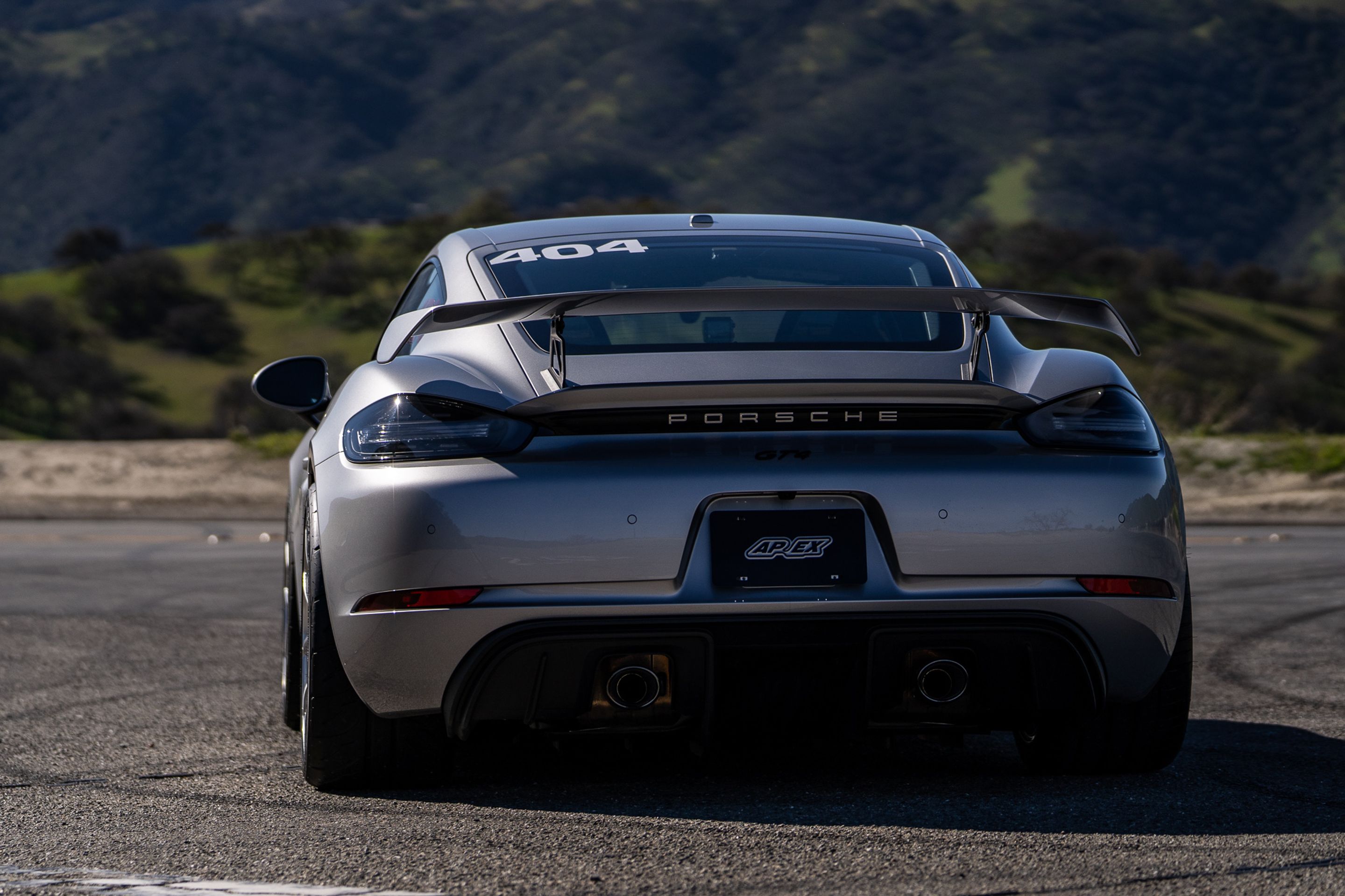Grey Porsche 718 Cayman GT4 with 19" VS-5RS Apex wheels in Brushed Clear