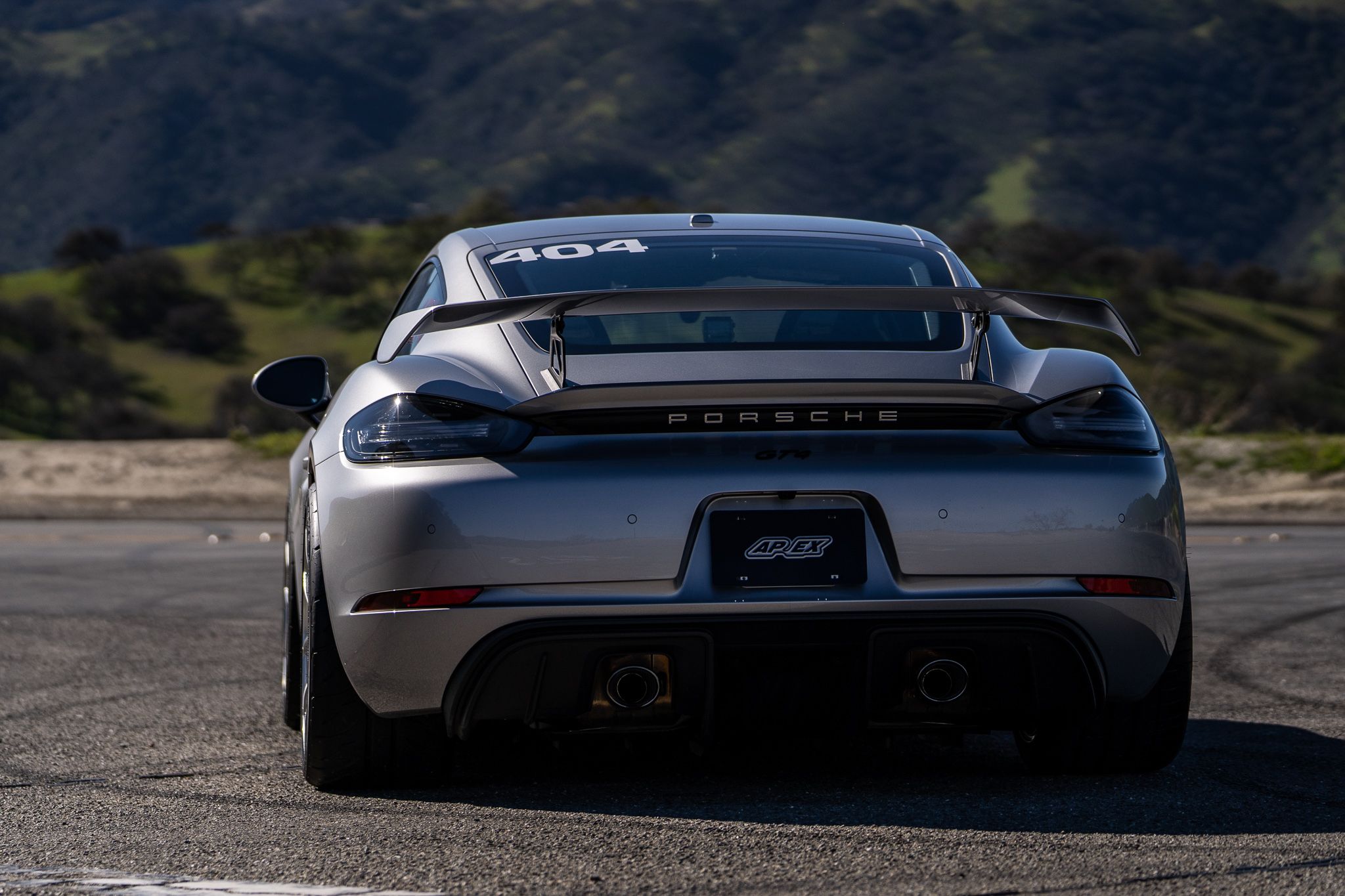 Grey Porsche 718 Cayman GT4 with 19" VS-5RS Apex wheels in Brushed Clear
