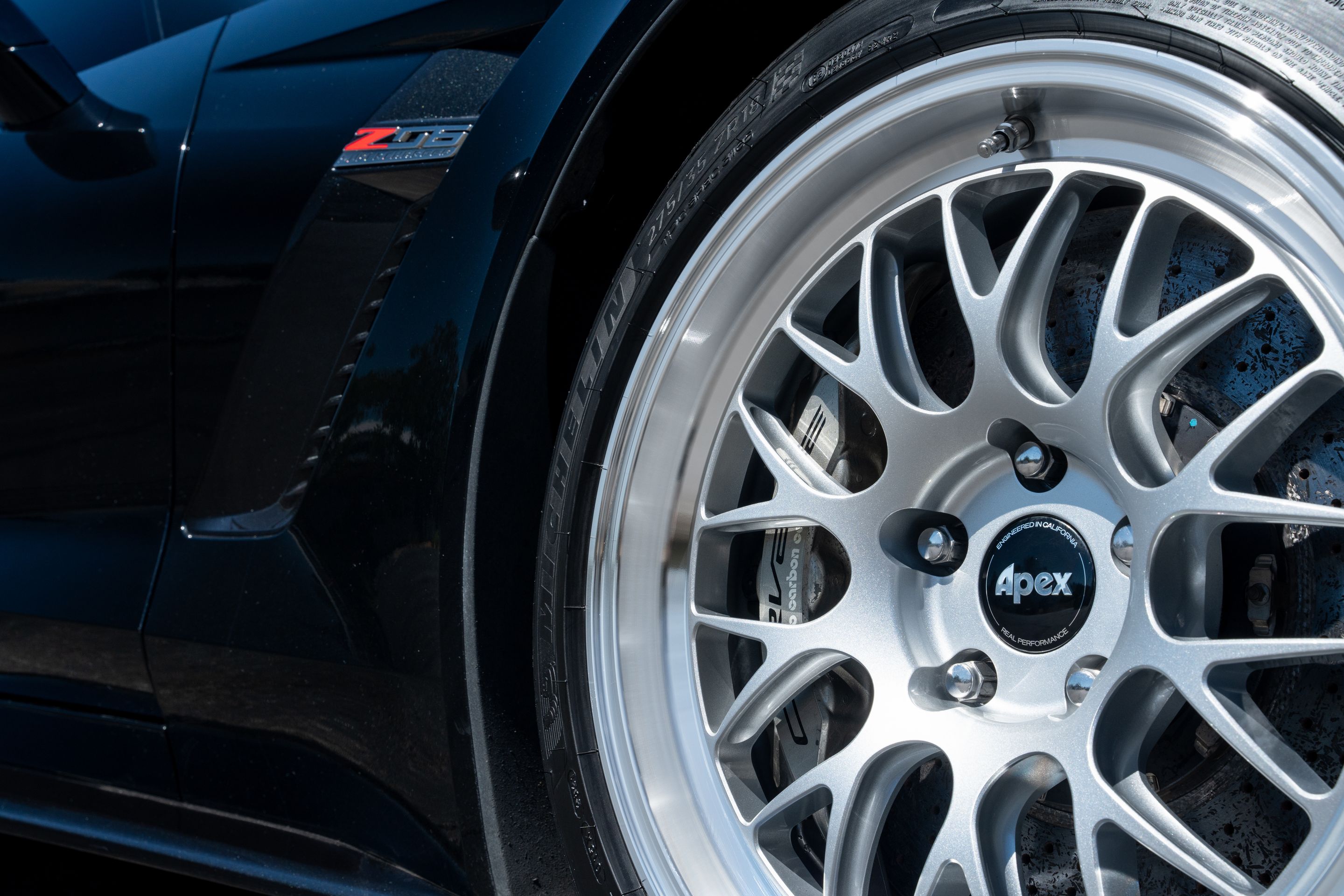 Black Chevrolet C7 Corvette Z06 with 18"/19" ML-10RT Apex wheels in Machined Lip Race Silver