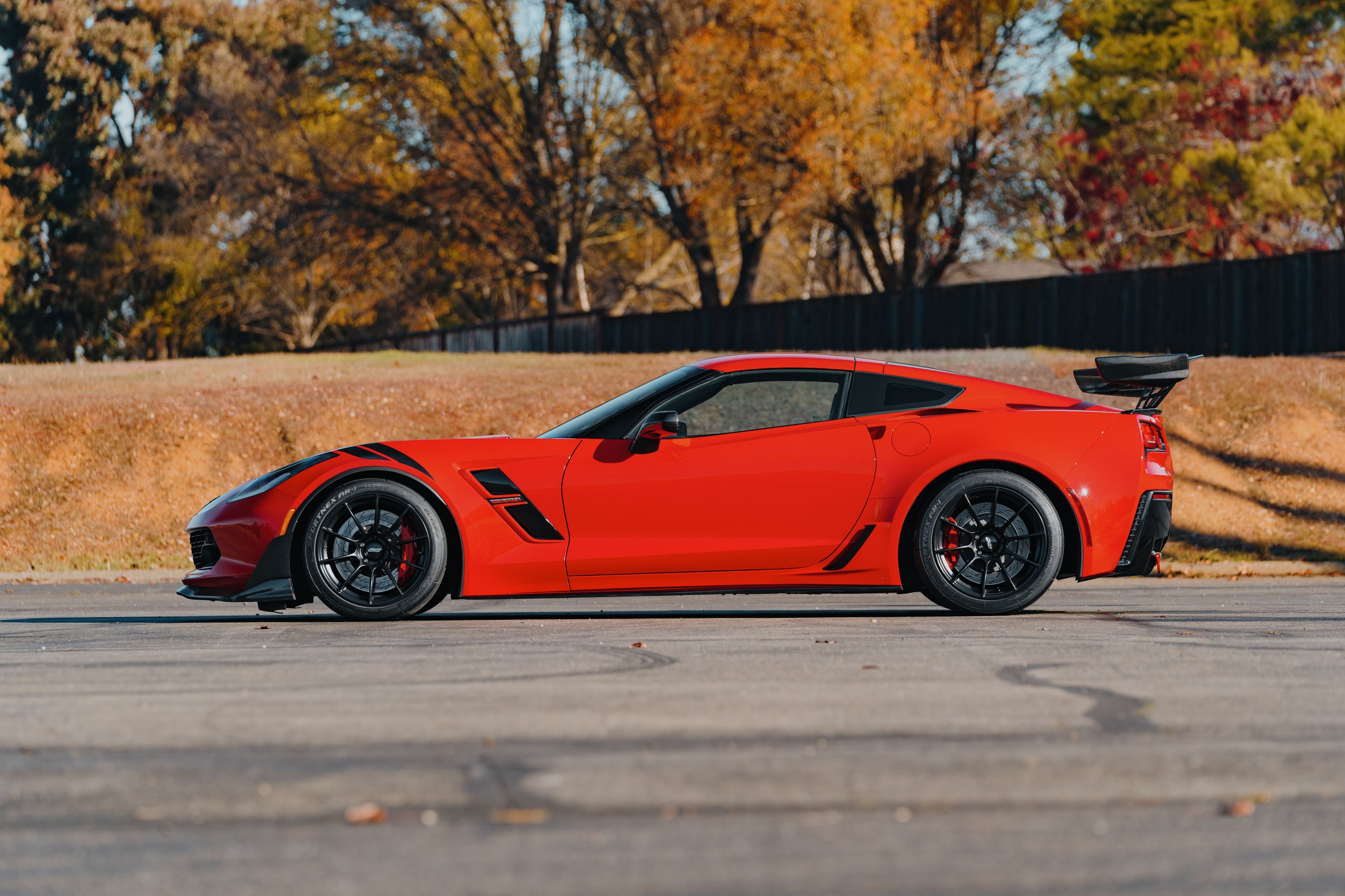 Red Chevrolet C7 Corvette Grand Sport with 18" SM-10RS Apex wheels in Satin Black
