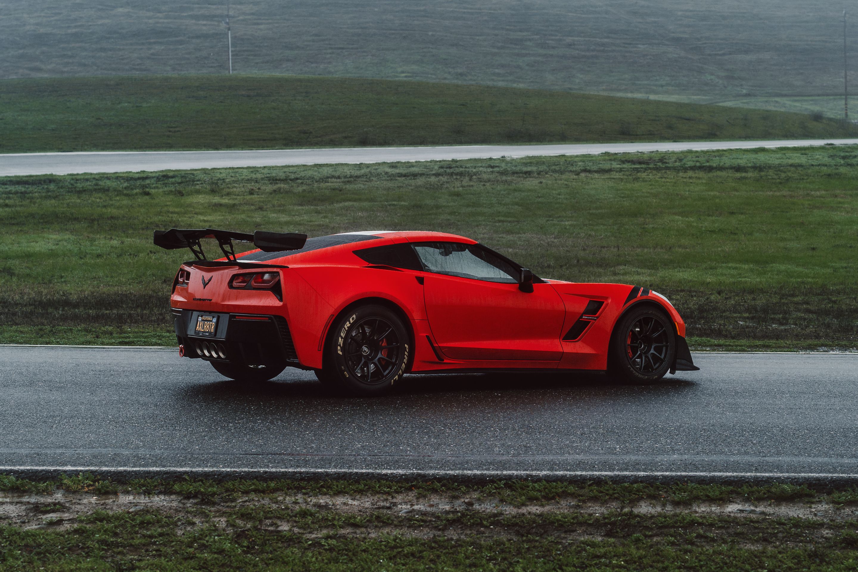 Red Chevrolet C7 Corvette Grand Sport with 18" SM-10RE Apex wheels in Satin Black