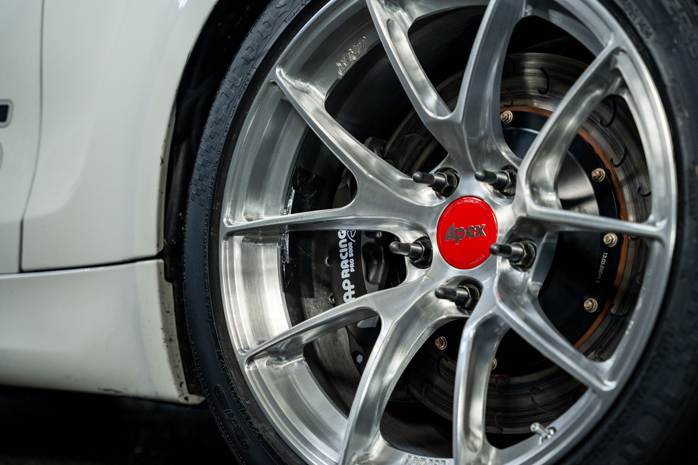 White BMW E82 1M with 18" VS-5RS Apex wheels in Brushed Clear