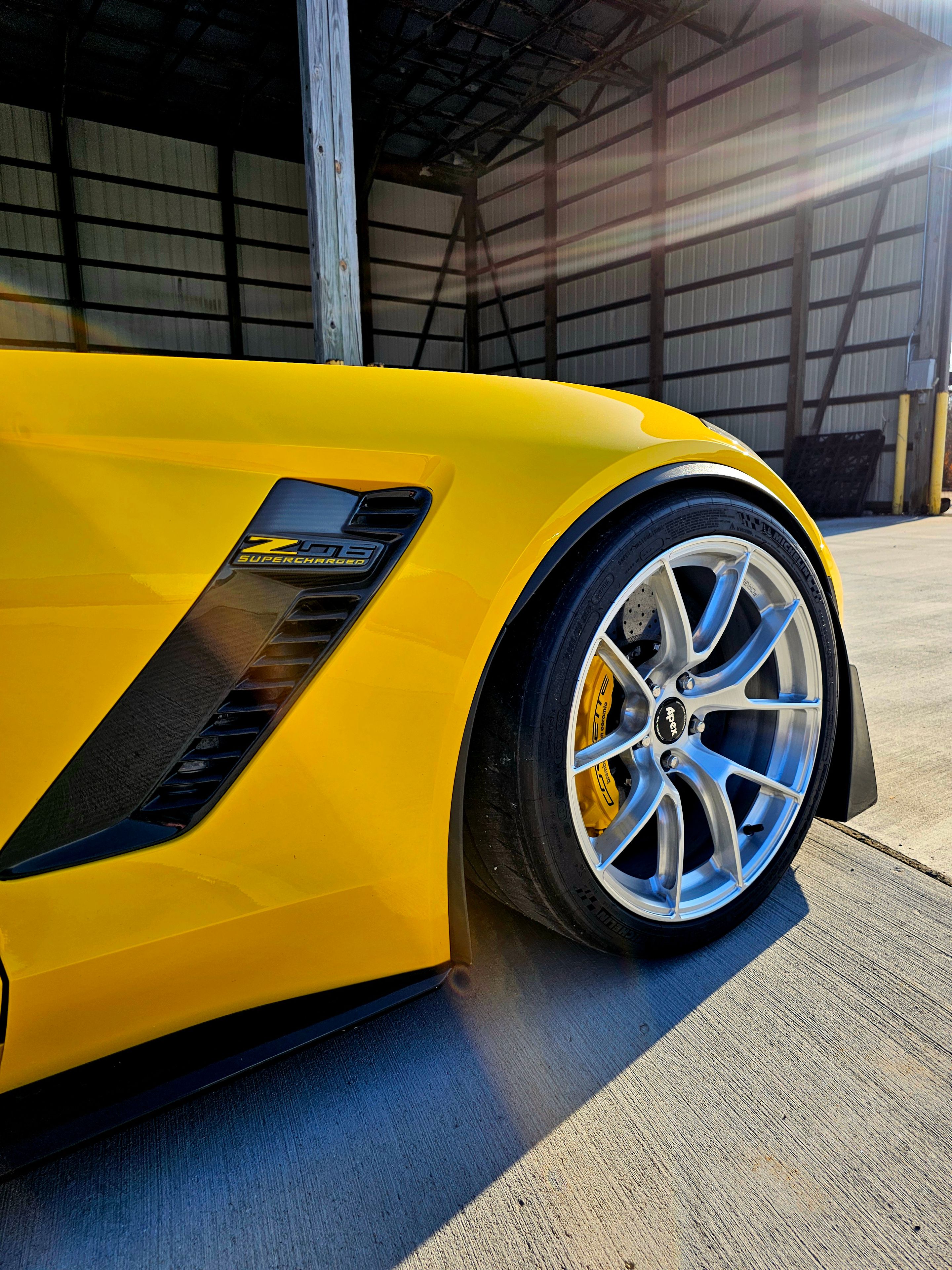 Yellow Chevrolet C7 Corvette Z06 with 19"/20" VS-5RS Apex wheels in Brushed Clear