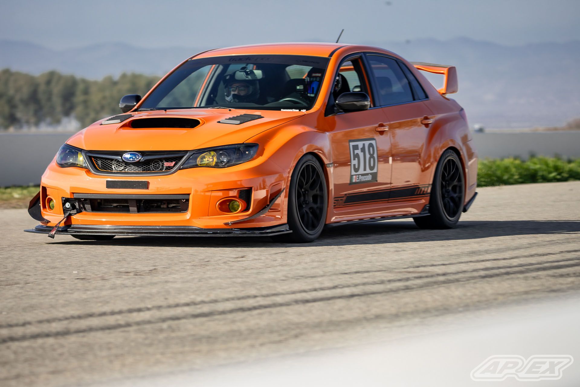 Orange Subaru GR WRX STI with 18" EC-7 Apex wheels in Satin Black
