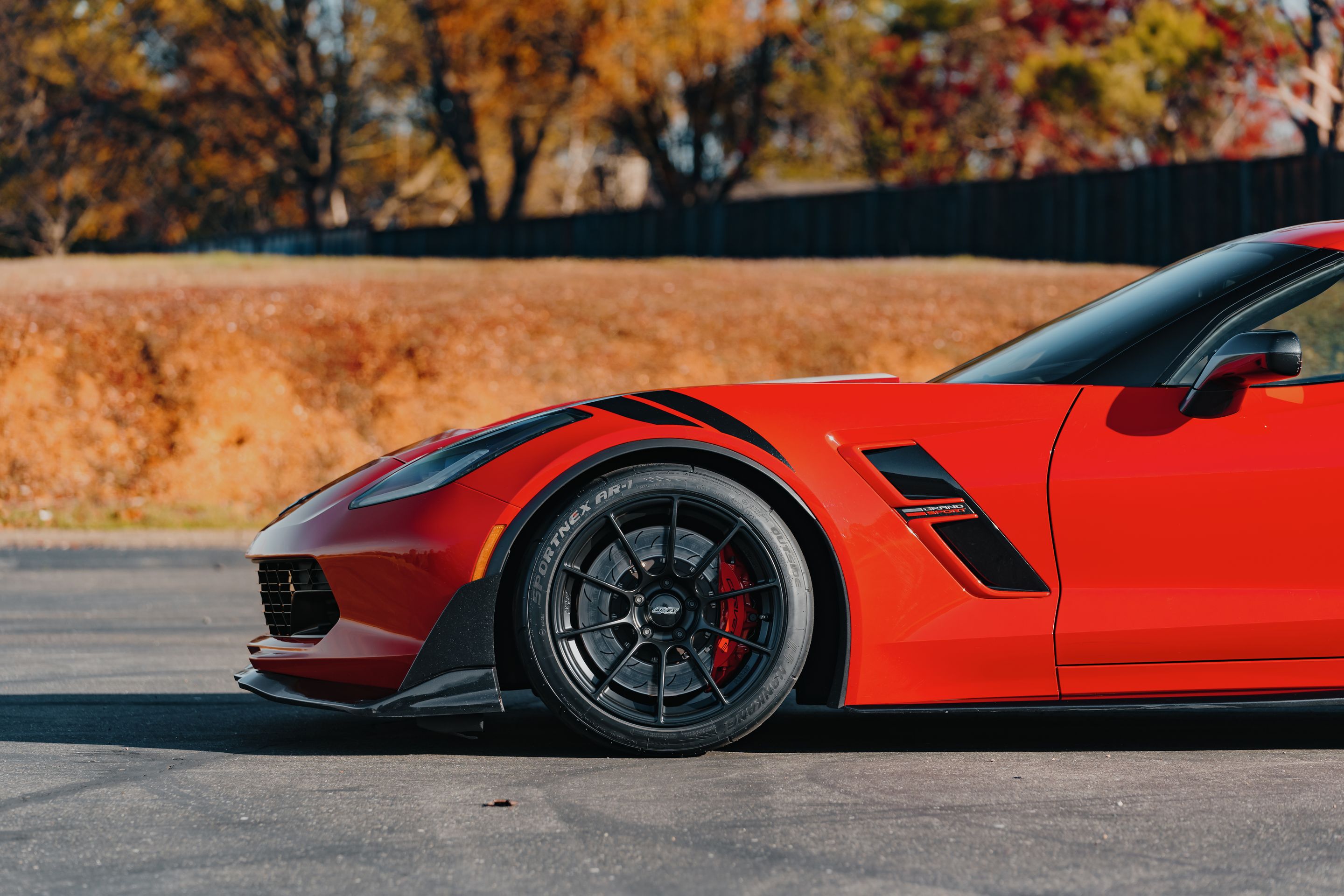 Red Chevrolet C7 Corvette Grand Sport with 18" SM-10RS Apex wheels in Satin Black