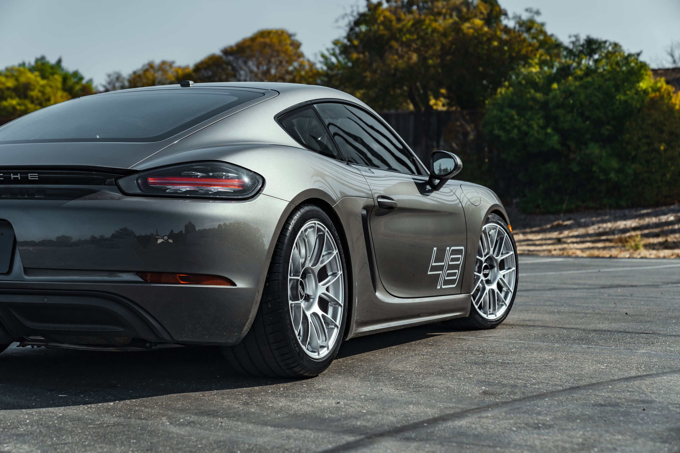 Grey Porsche 718 Cayman S with 19" EC-7RS Apex wheels in Race Silver