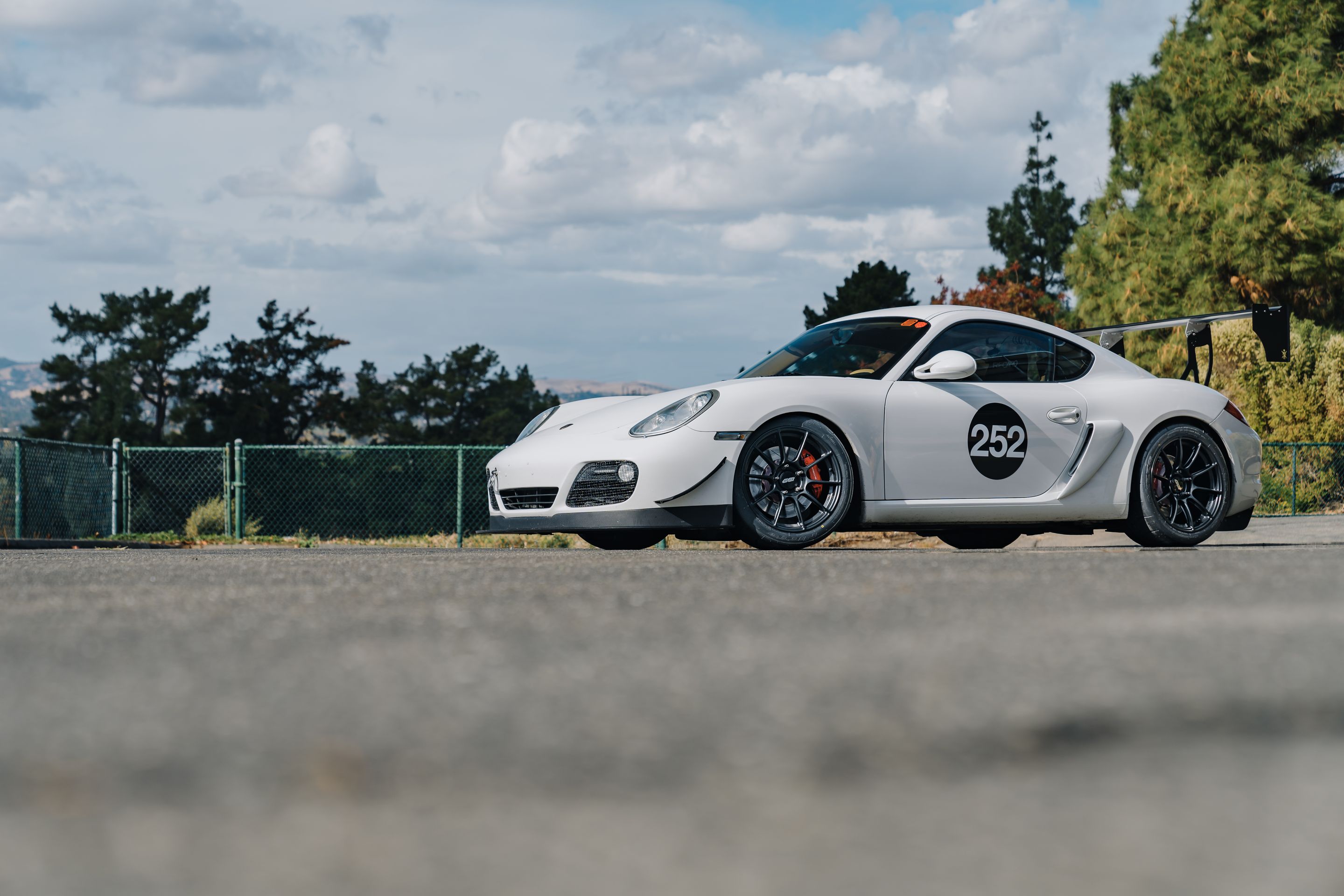 White Porsche 987 Cayman S with 18" SM-10RS Apex wheels in Satin Black