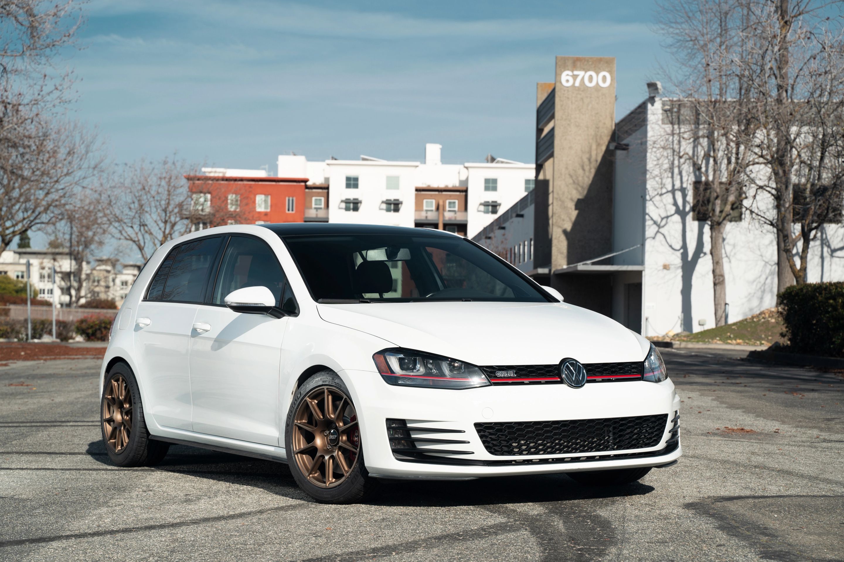 White VW MK7 GTI with 17" SM-10 Apex wheels in Satin Bronze