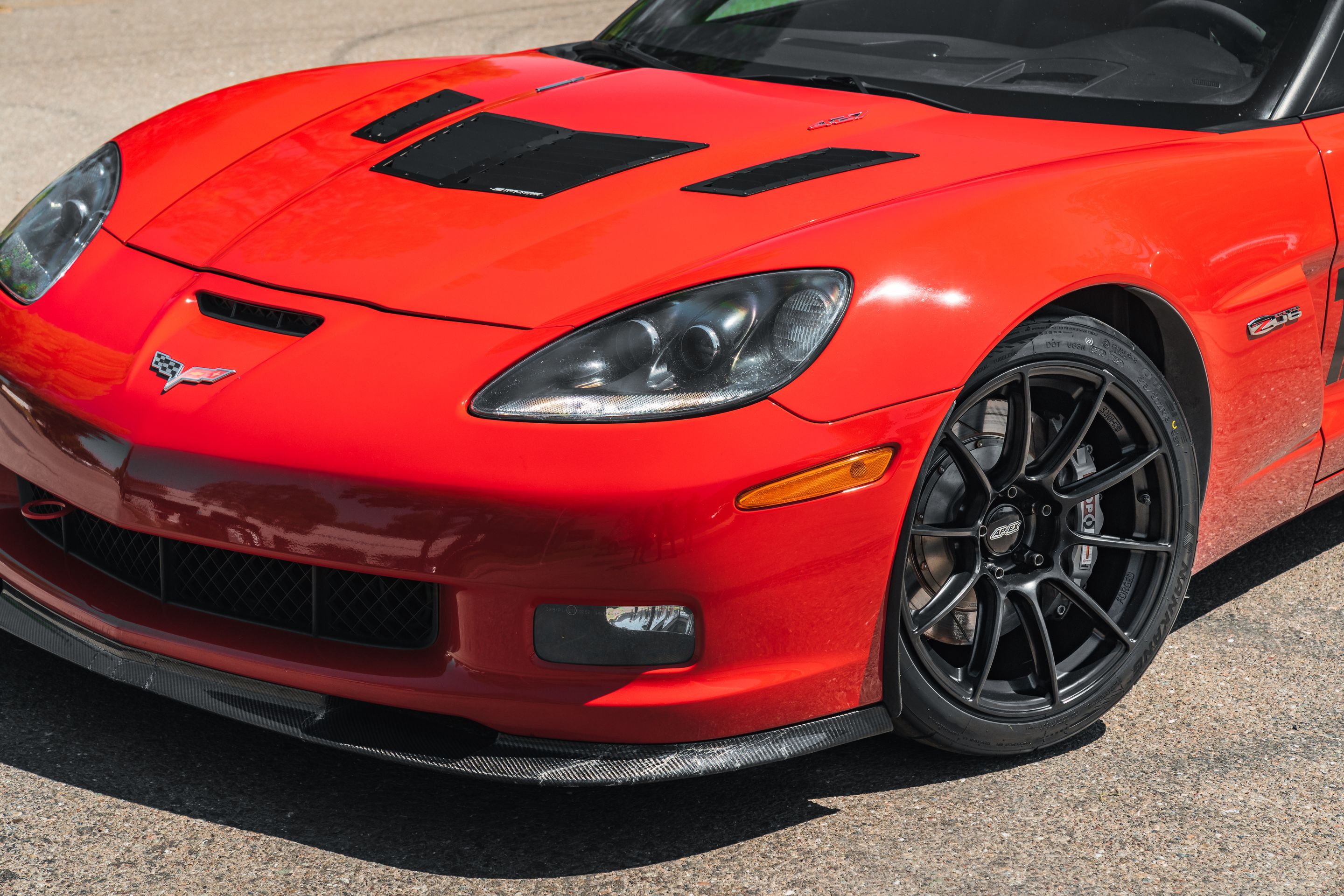 Red Chevrolet C6 Corvette Z06 with 18" SM-10RS Apex wheels in Satin Black