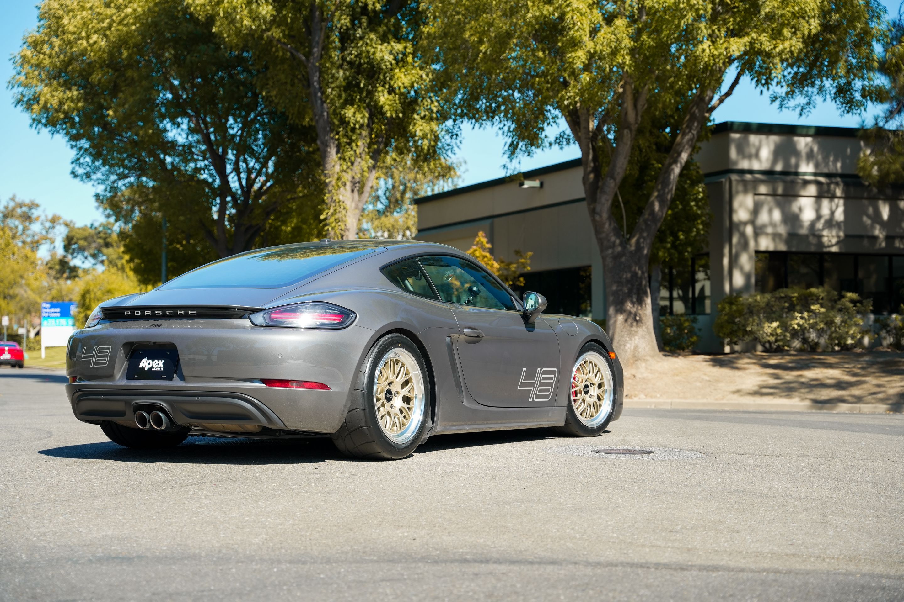 Grey Porsche 718 Cayman S with 18" ML-10RT Apex wheels in Machined Lip Gloss Motorsport Gold
