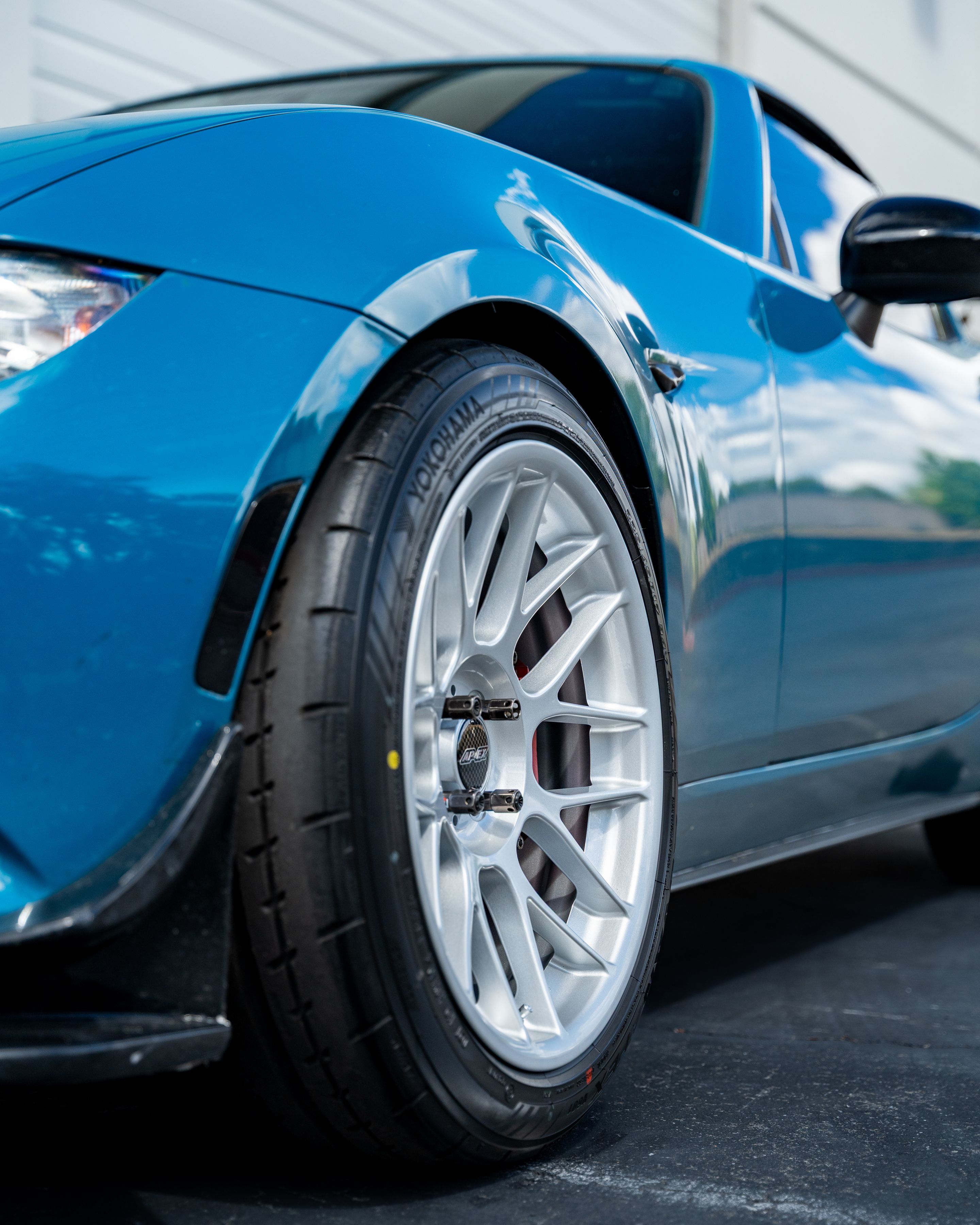 Blue Mazda ND MX-5 Miata with 17" ARC-8 Apex wheels in Race Silver