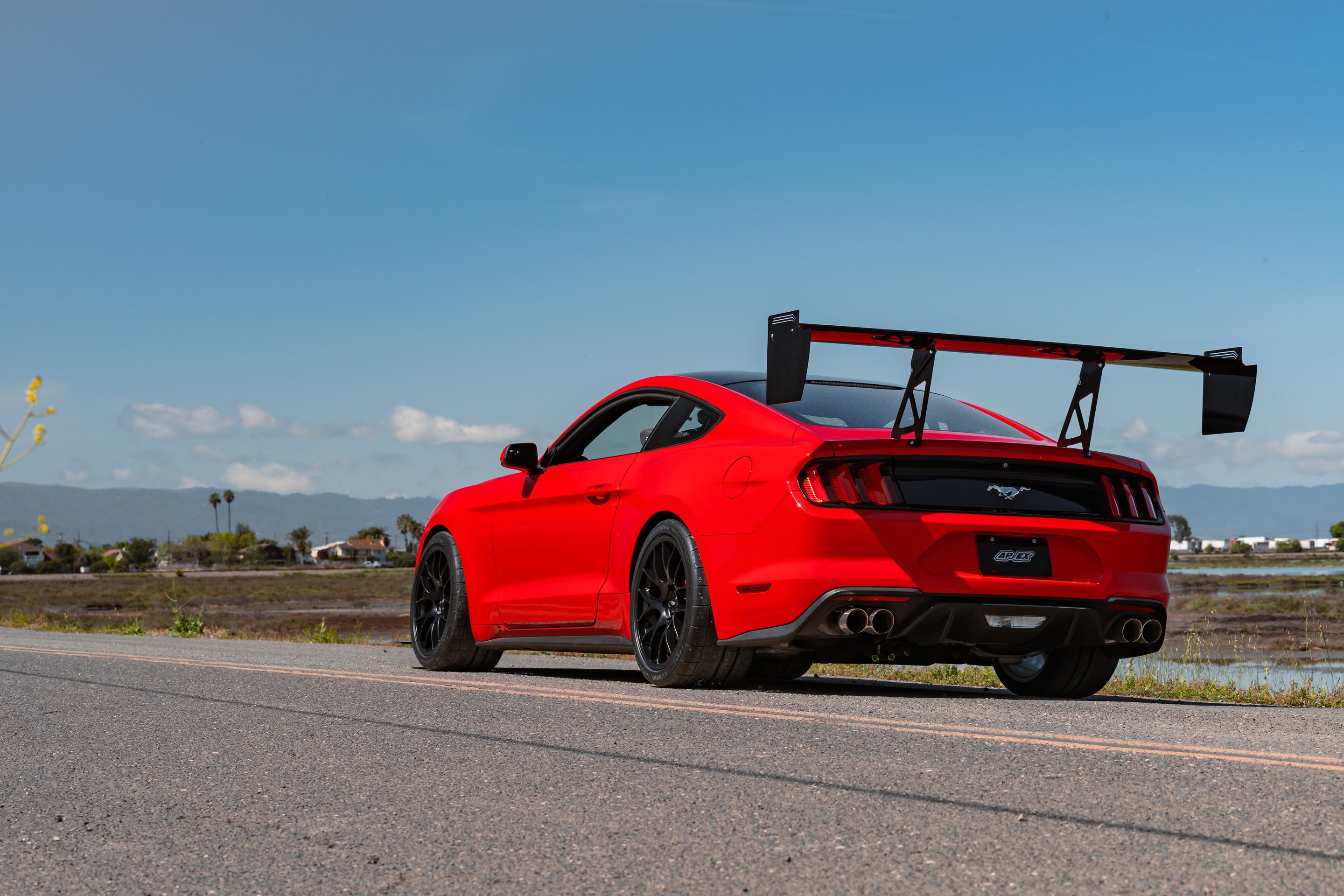 Red Ford S550 Mustang GT with 19" EC-7 Apex wheels in Satin Black