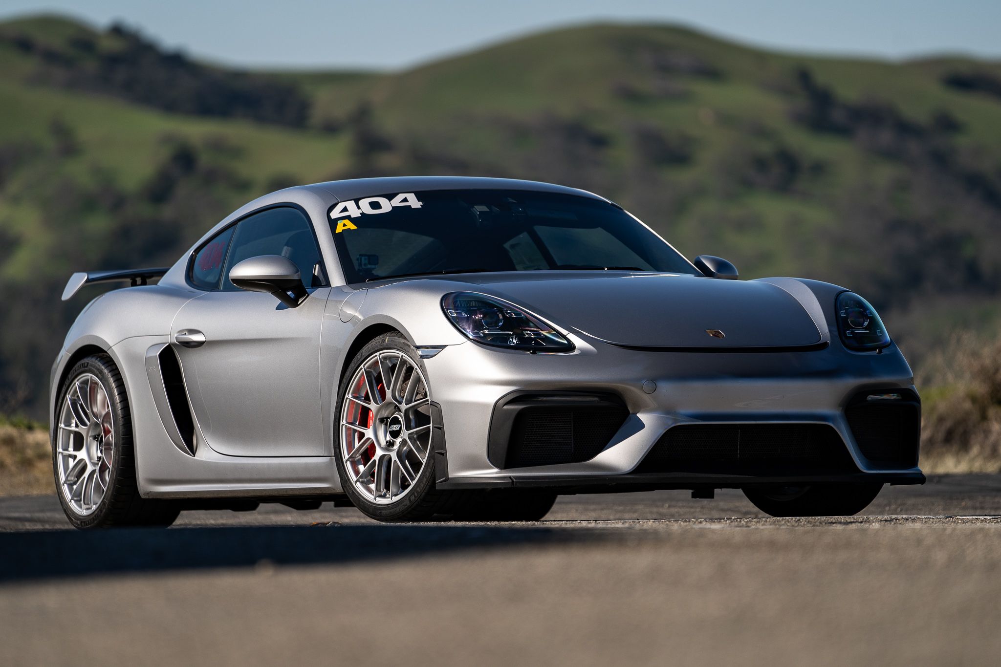 Grey Porsche 718 Cayman GT4 with 19" EC-7RS Apex wheels in Race Silver
