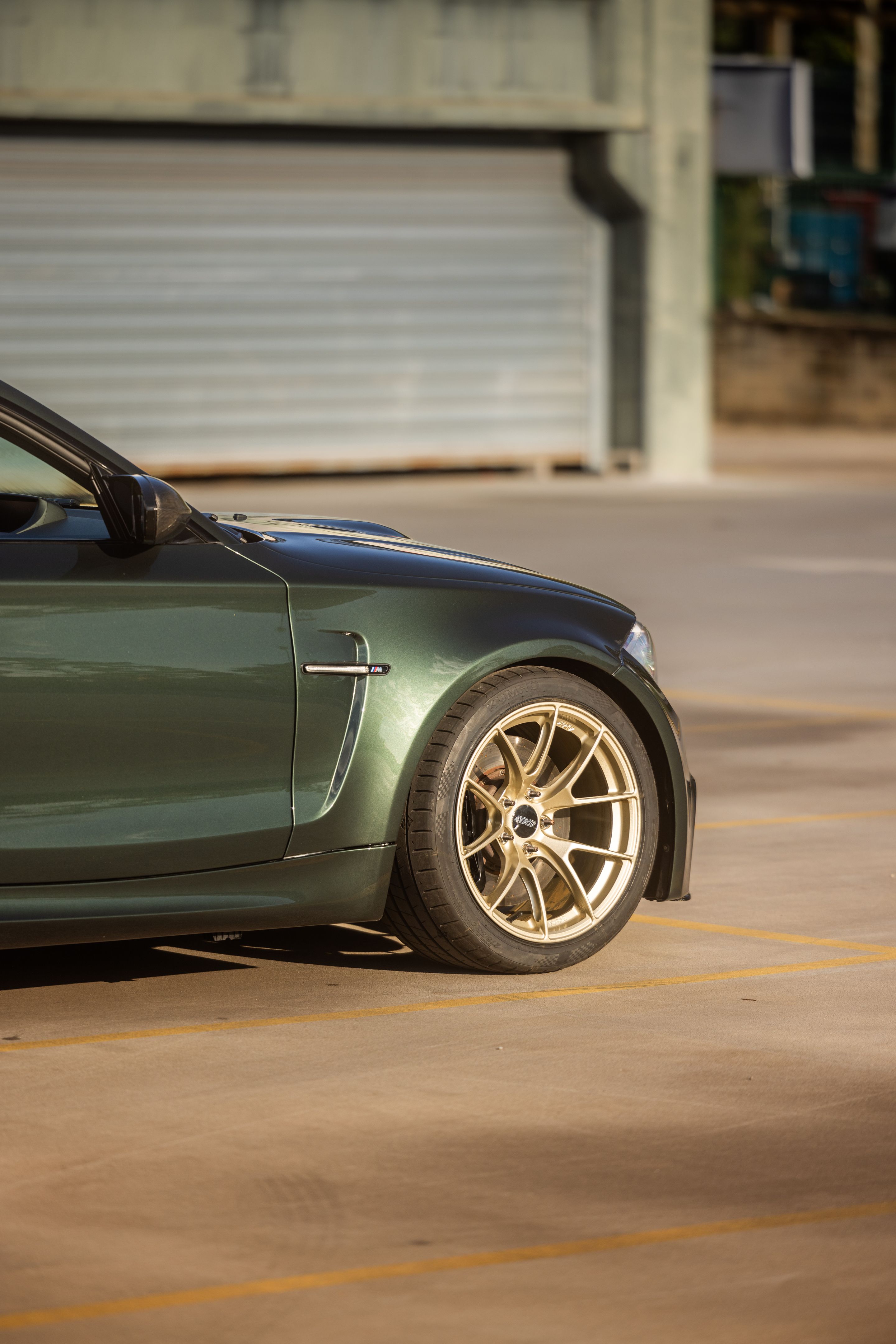 Green BMW E82 1M with 18" VS-5RS Apex wheels in Motorsport Gold