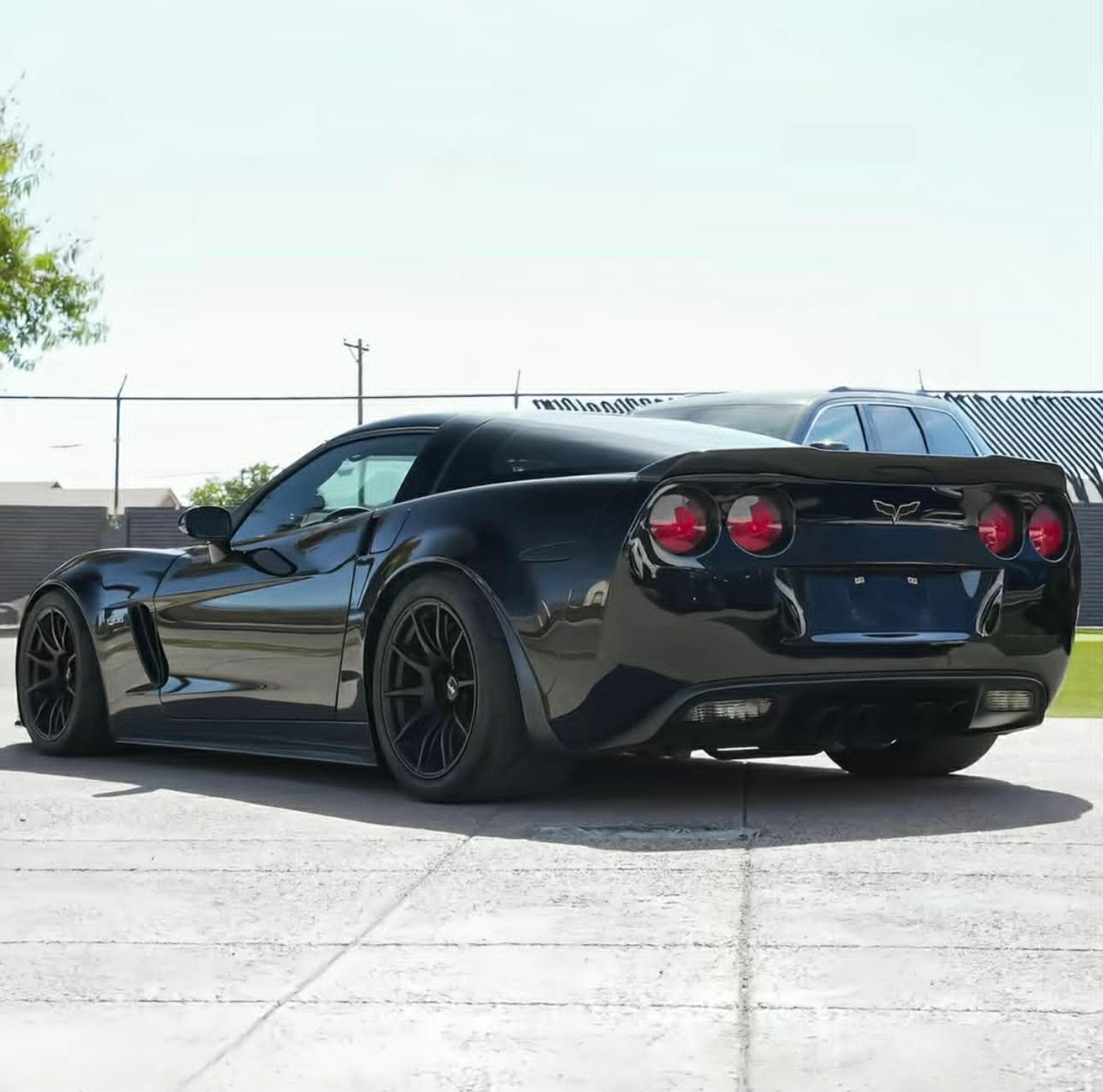 Black Chevrolet C6 Corvette Z06 with 18" SM-10 Apex wheels in Satin Black