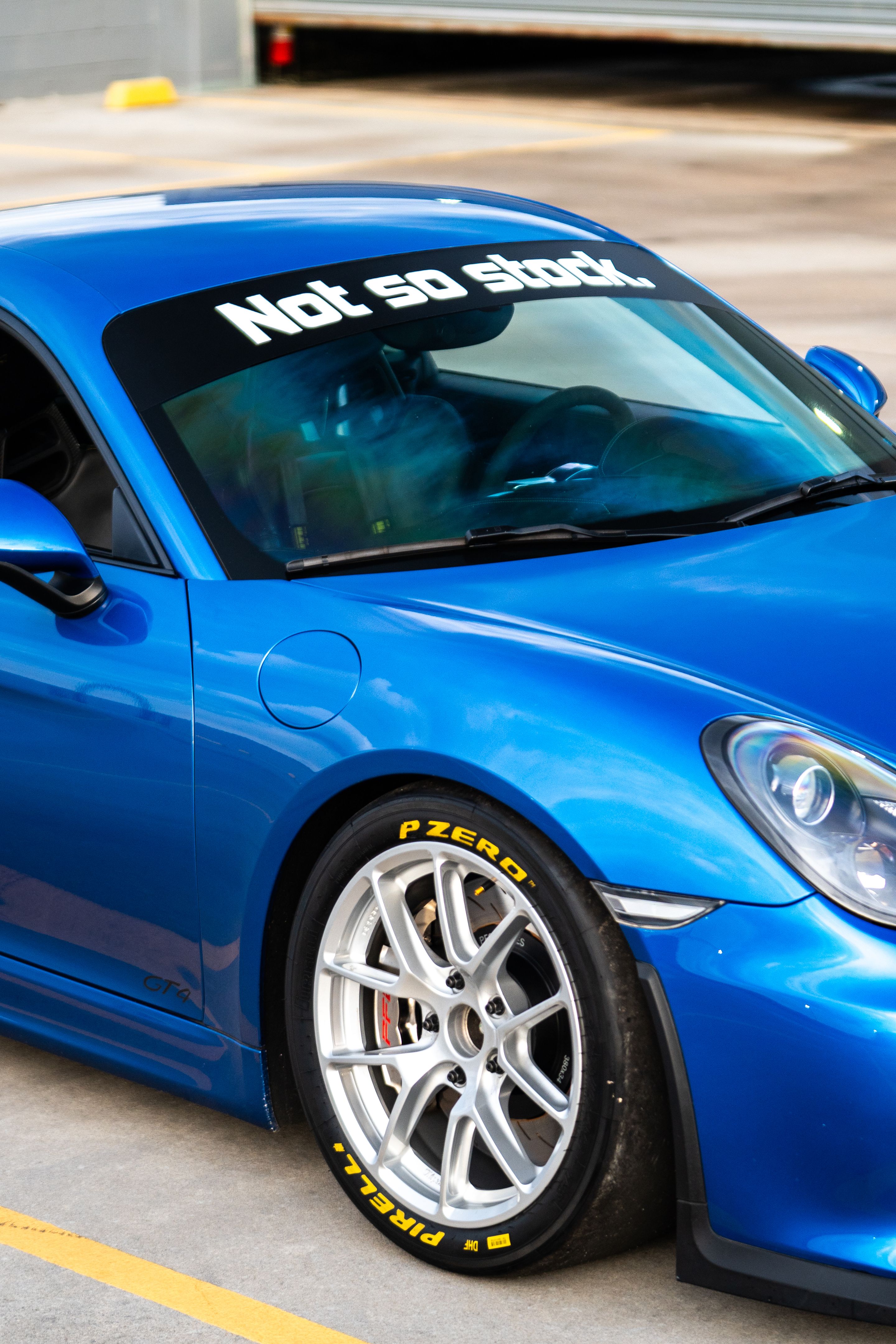 Blue Porsche 981 Cayman GT4 with 18" VS-5RE Apex wheels in Race Silver