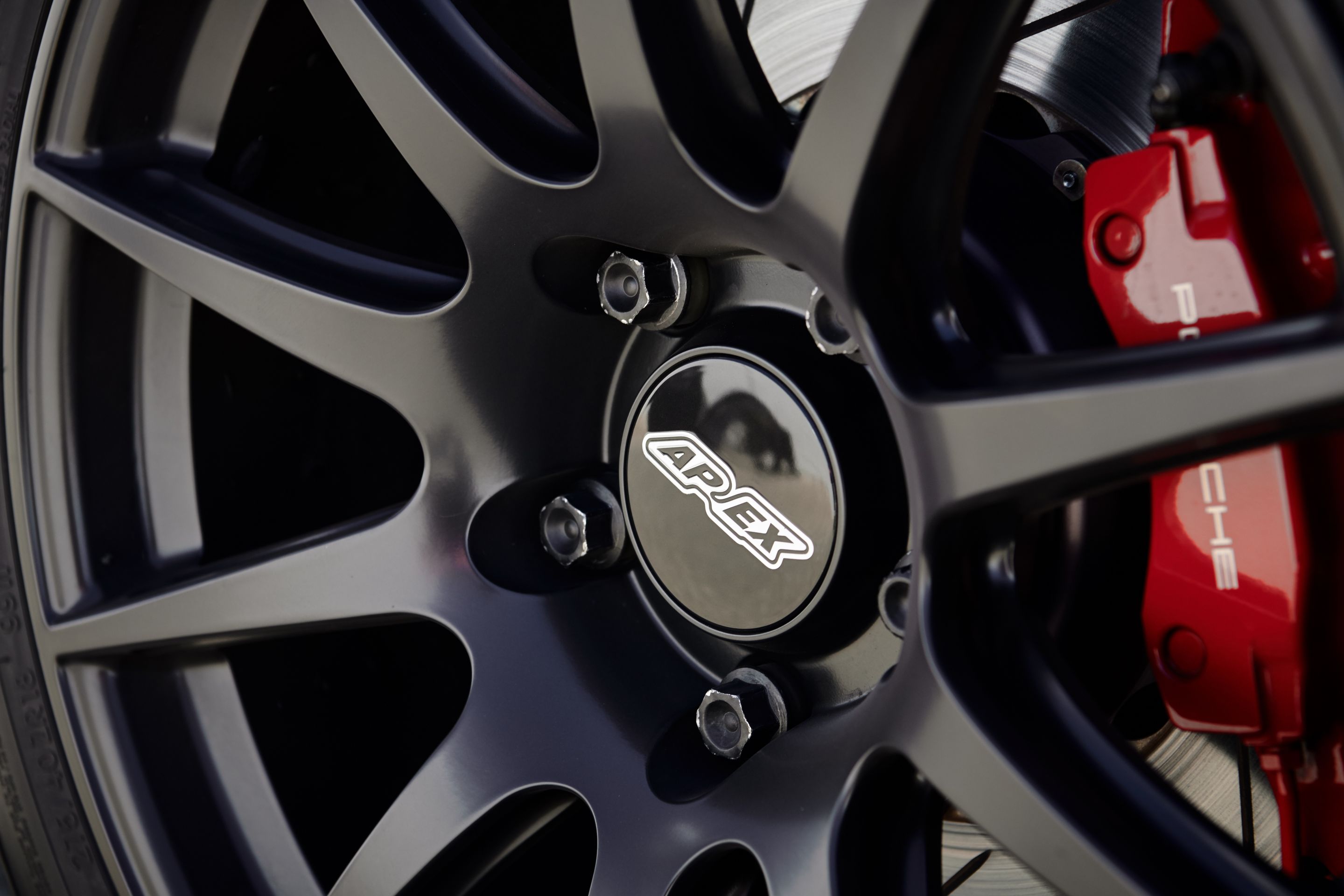 White Porsche 718 Cayman S with 18" SM-10 Apex wheels in Satin Black