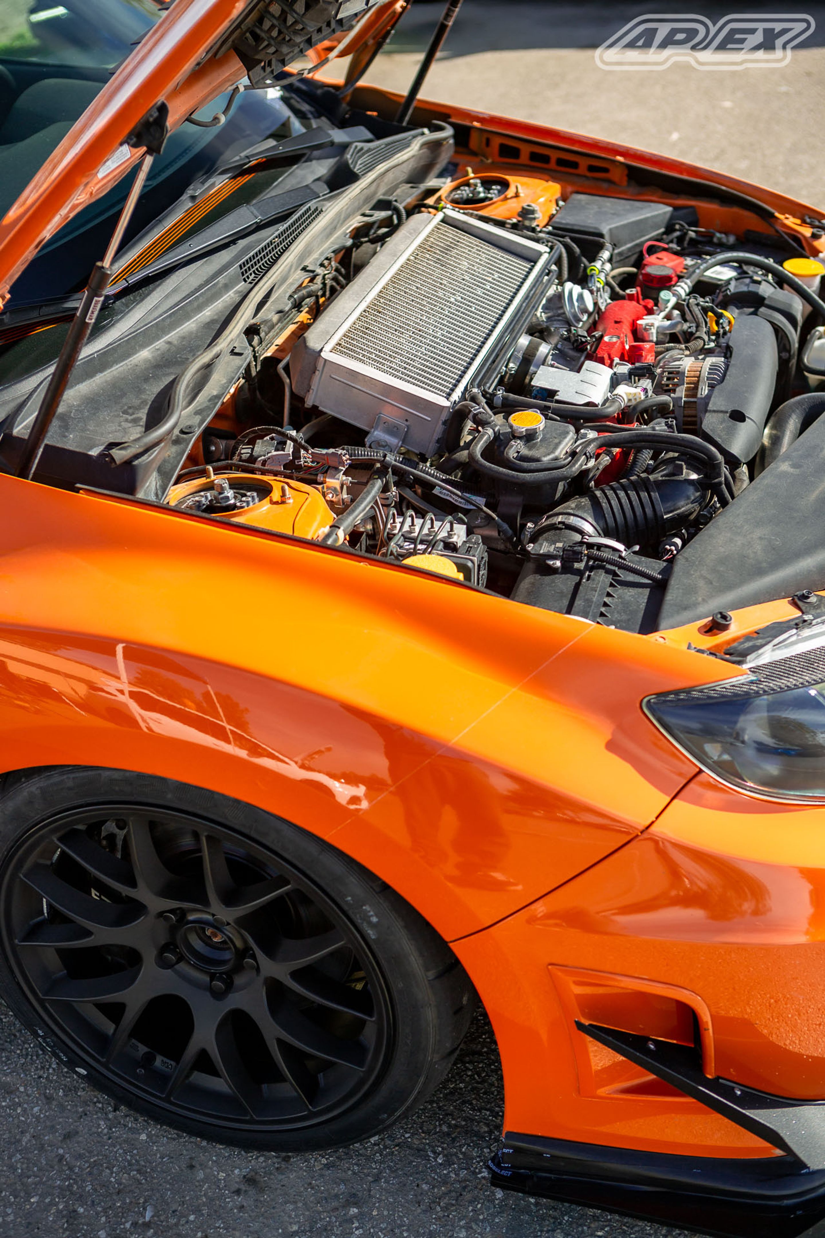 Orange Subaru GR WRX STI with 18" EC-7 Apex wheels in Satin Black