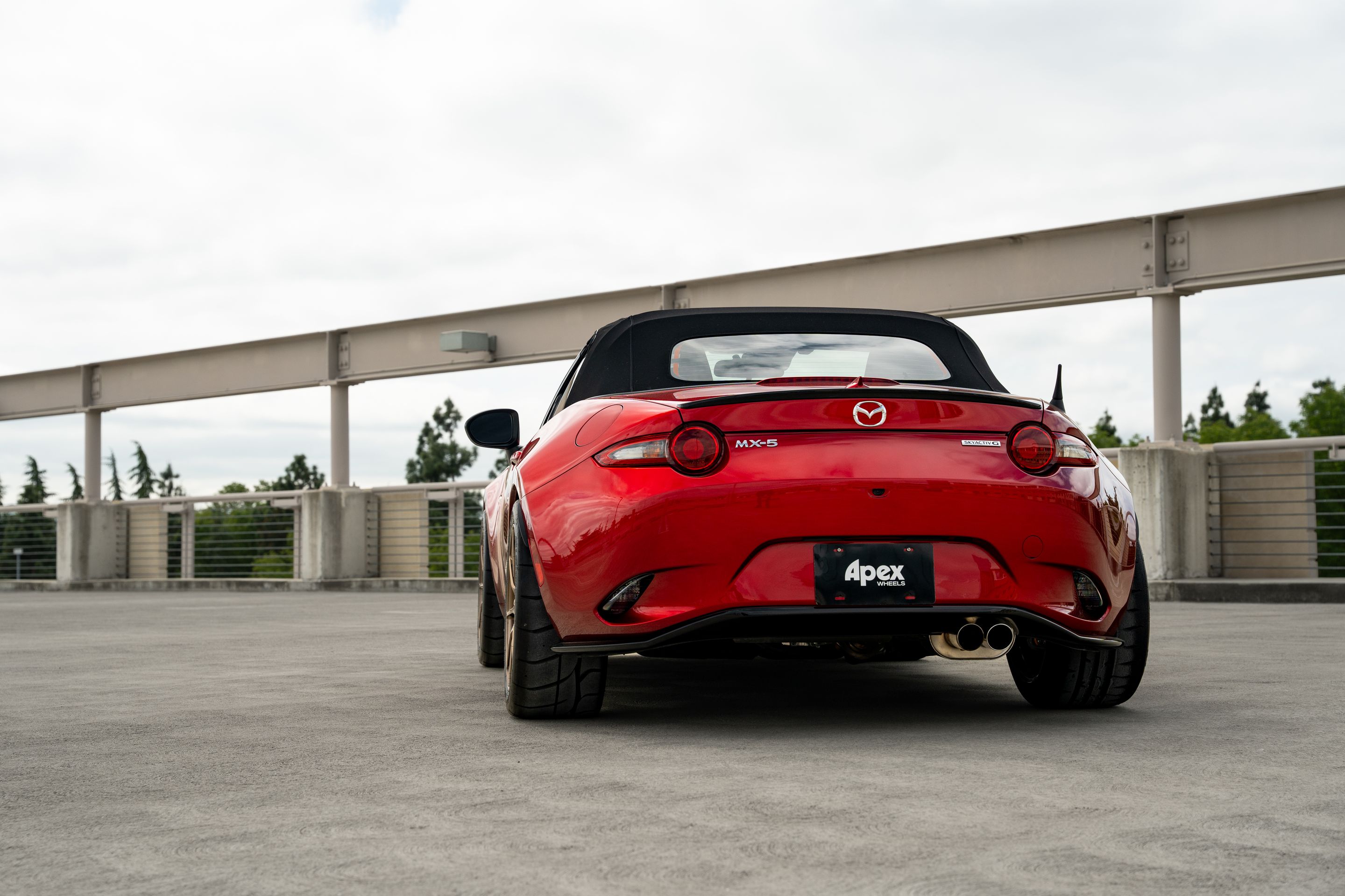 Red Mazda ND MX-5 Miata with 17" SM-8RS Apex wheels in Satin Bronze