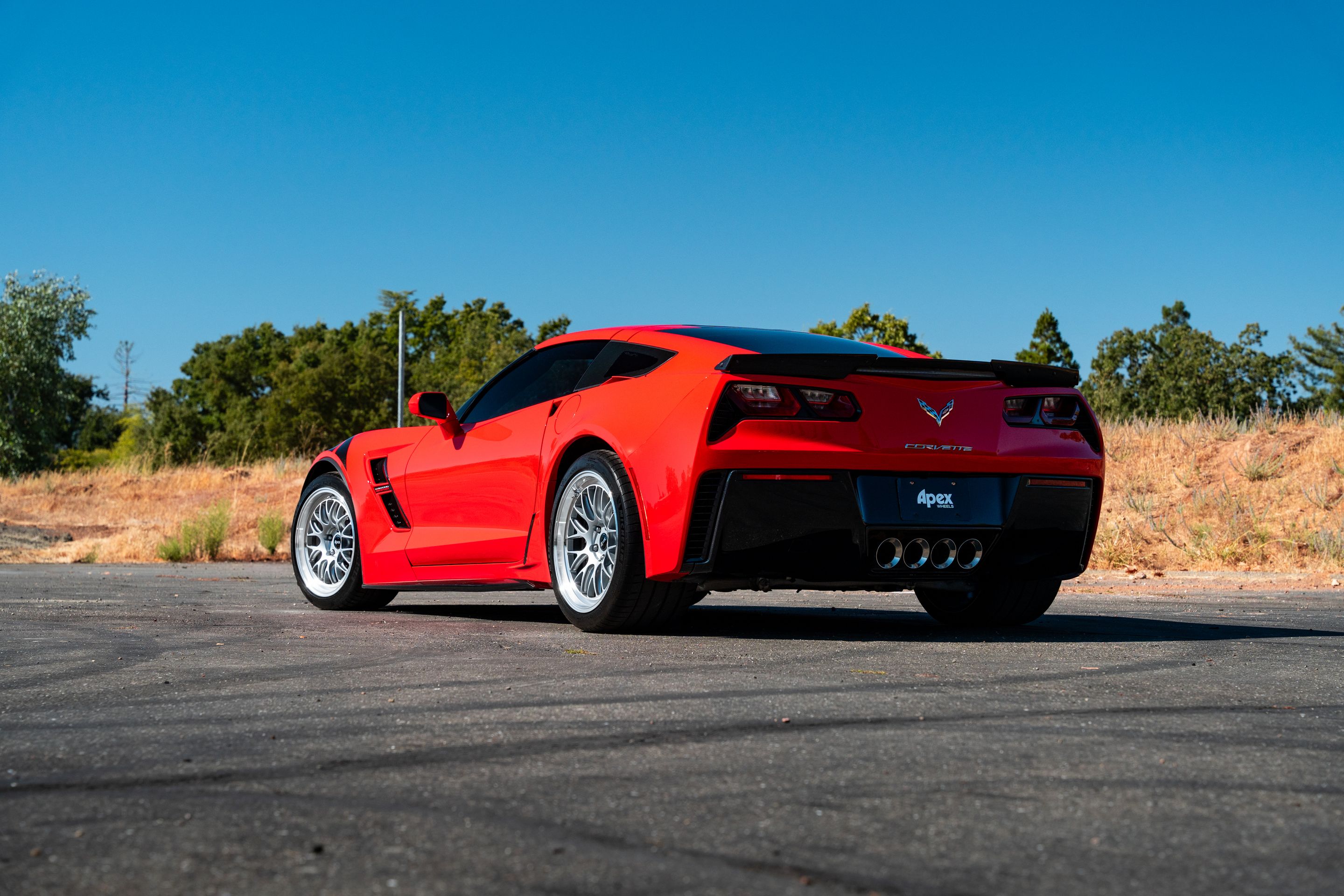 Red Chevrolet C7 Corvette Grand Sport with 18"/19" ML-10RT Apex wheels in Machined Lip Race Silver