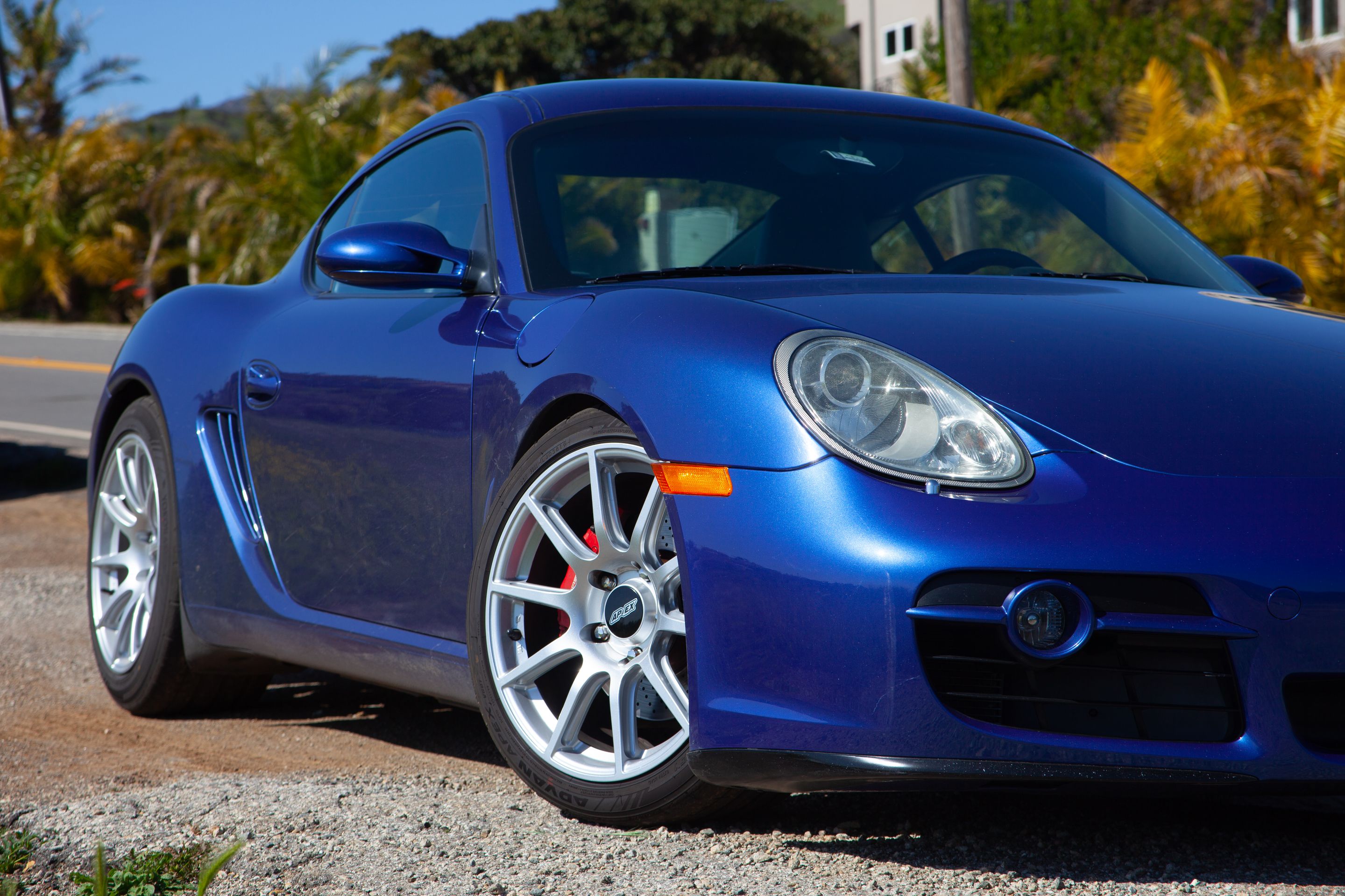 Blue Porsche 987 Cayman S with 18" SM-10 Apex wheels in Race Silver