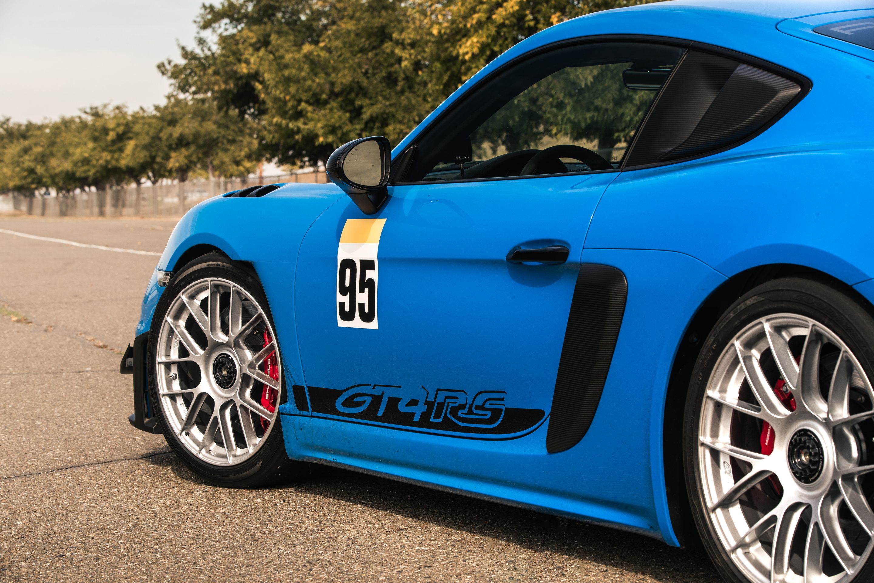 Blue Porsche 718 Cayman GT4 RS with 19" EC-7RS Apex wheels in Race Silver