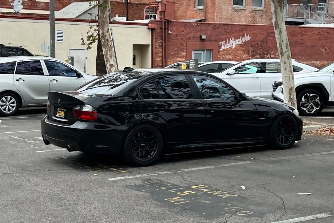 Black BMW E90 Sedan 3 Series with 17" ARC-8 Apex wheels in Satin Black