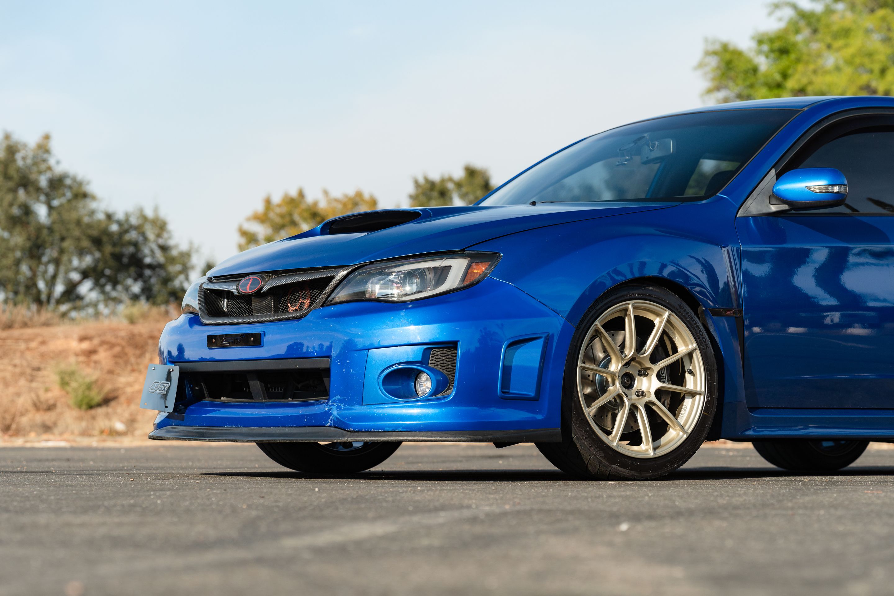 Blue Subaru GR WRX STI with 18" SM-10RS Apex wheels in Motorsport Gold