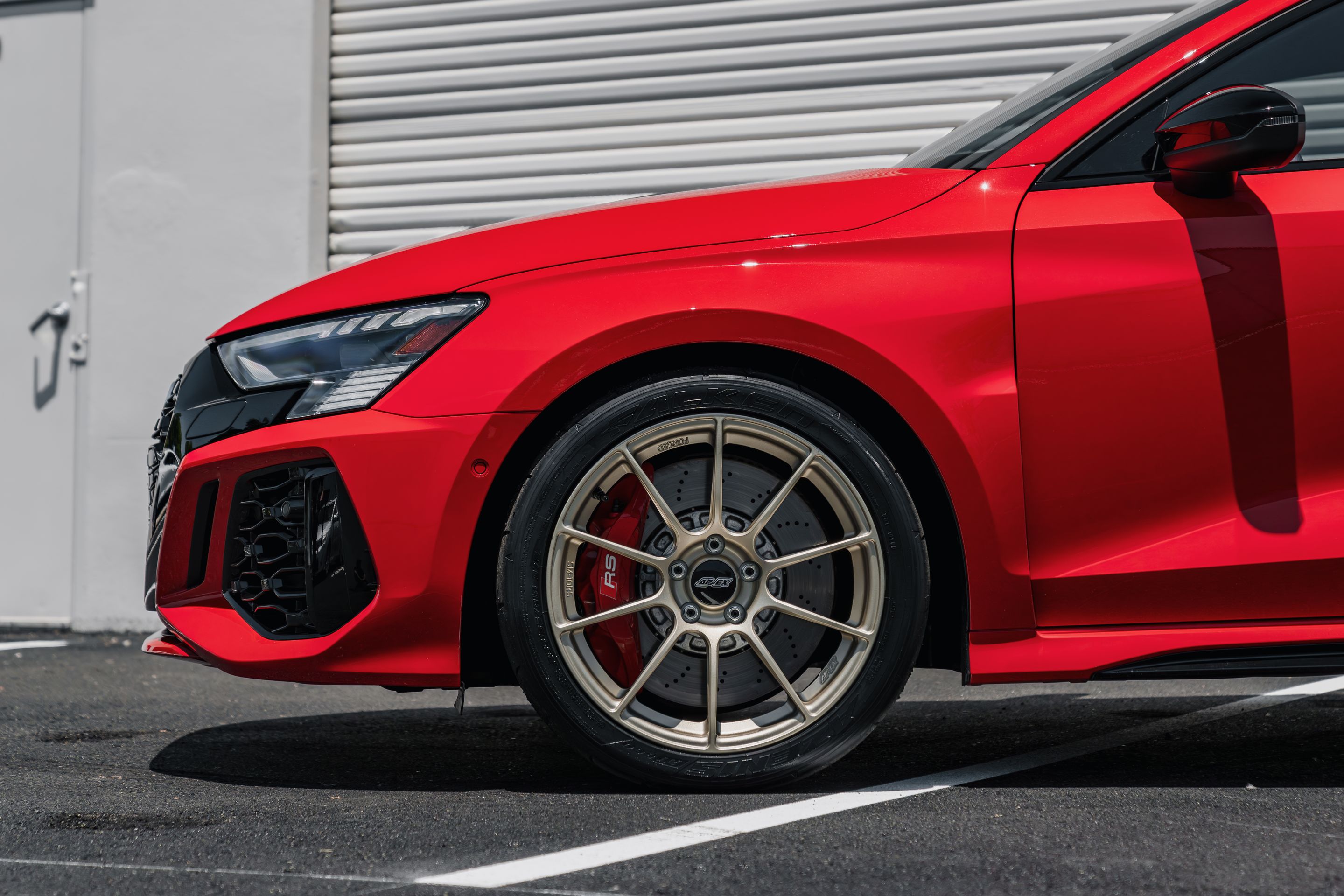 Red Audi 8Y RS 3 with 18" SM-10RS Apex wheels in Motorsport Gold
