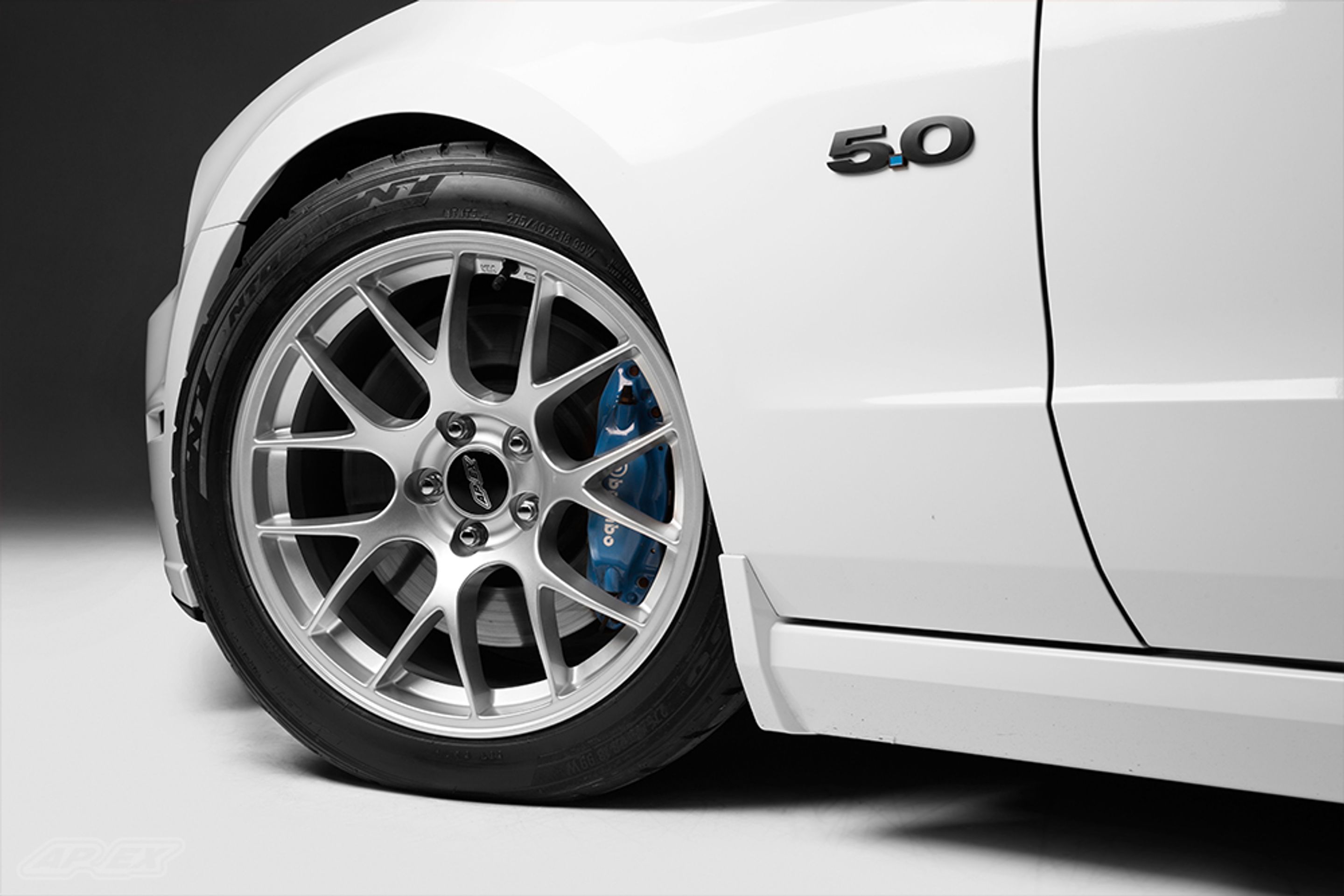 White Ford S197 Mustang GT with 18" EC-7 Apex wheels in Race Silver