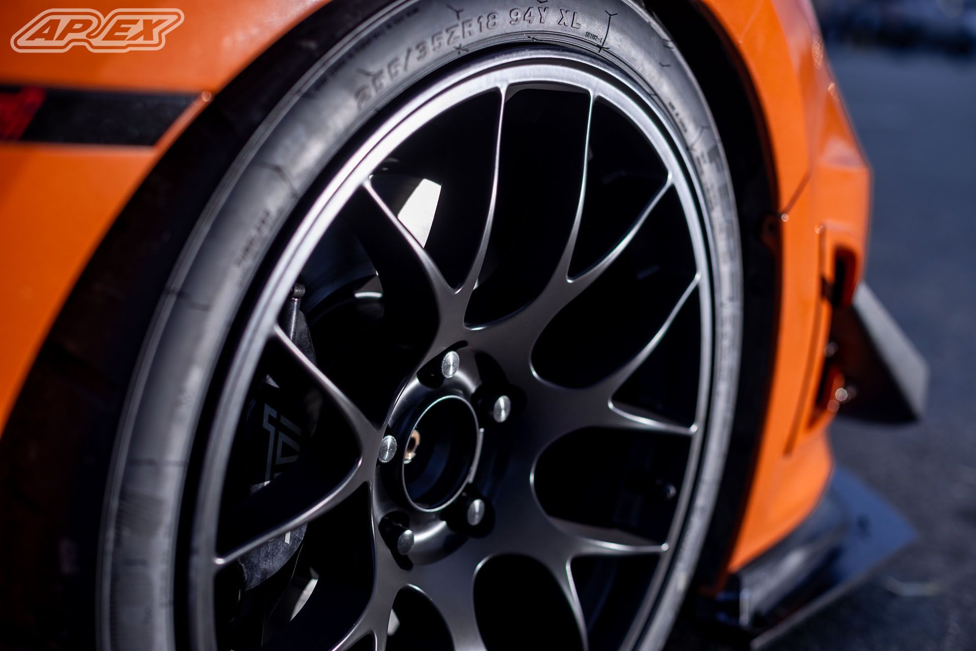 Orange Subaru GR WRX STI with 18" EC-7 Apex wheels in Satin Black