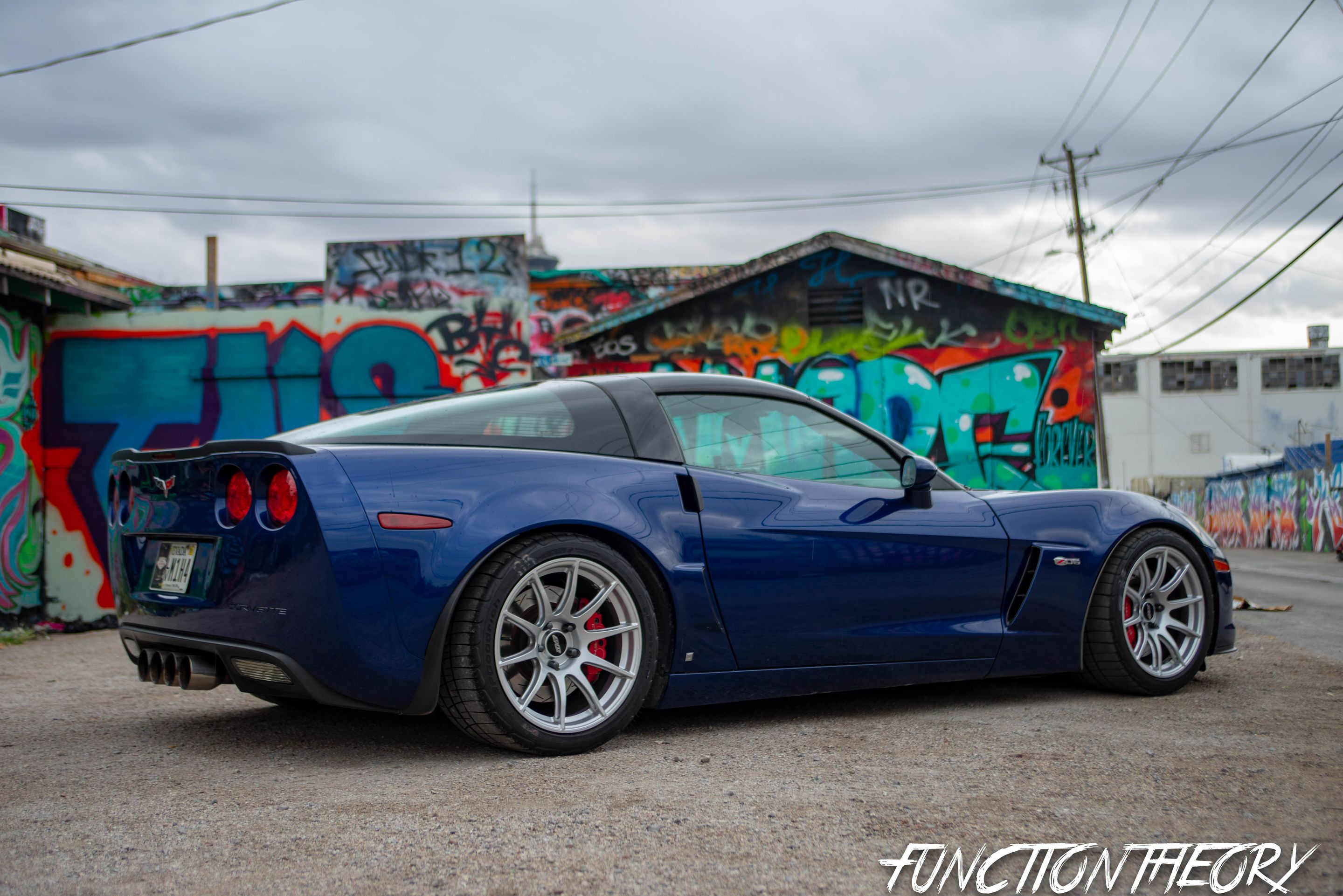 Blue Chevrolet C6 Corvette Z06 with 18" SM-10 Apex wheels in Race Silver
