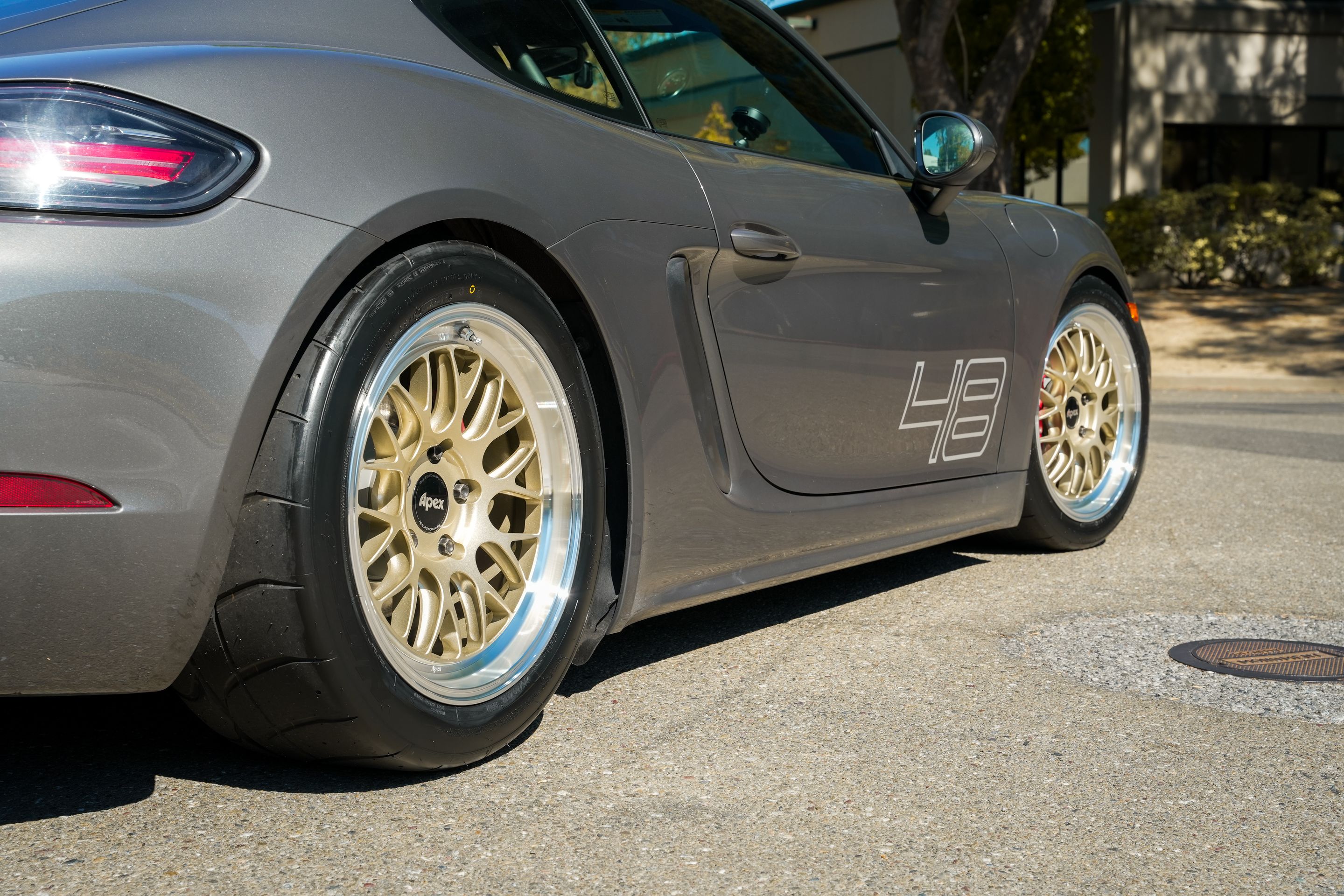Grey Porsche 718 Cayman S with 18" ML-10RT Apex wheels in Machined Lip Gloss Motorsport Gold