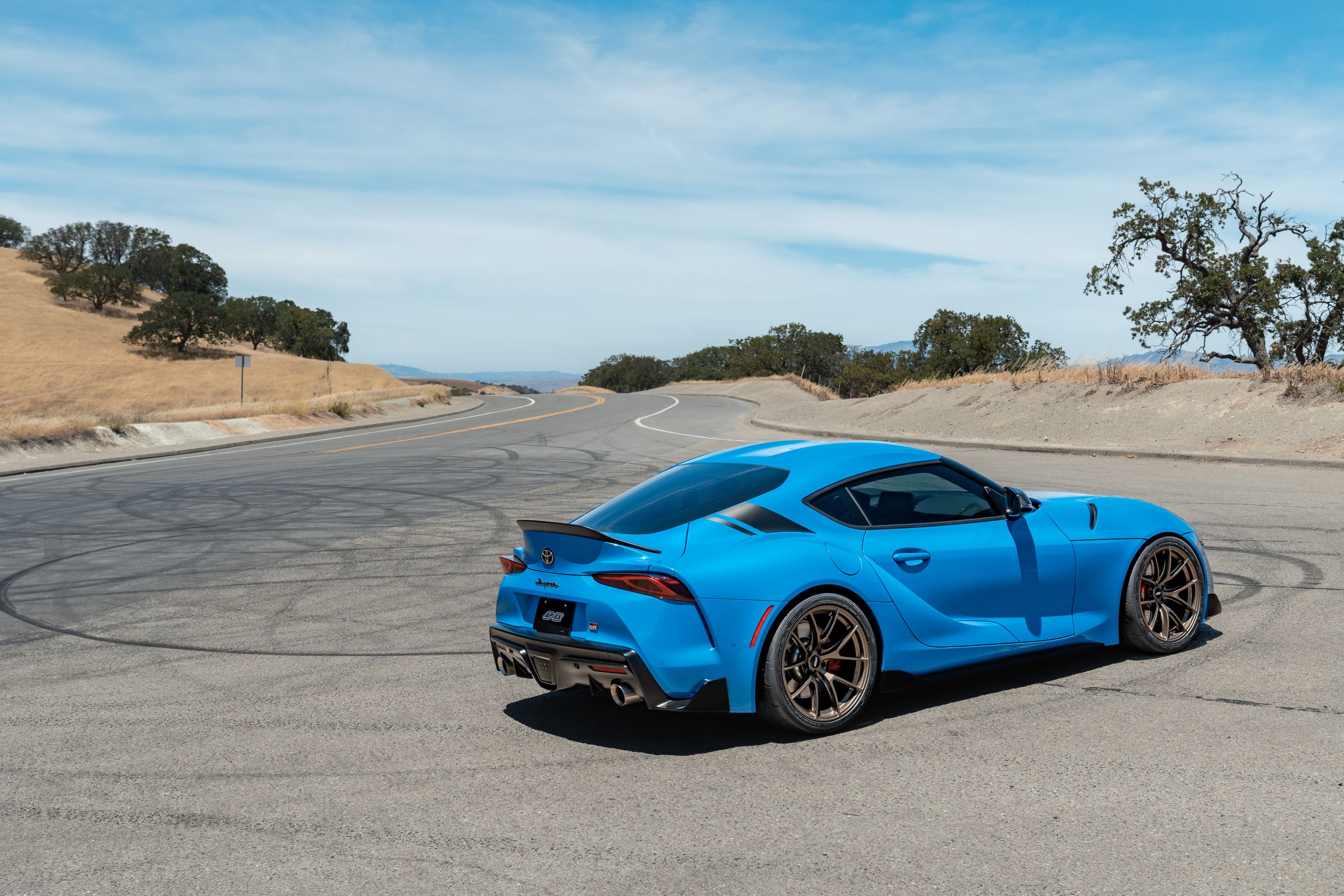 Blue Toyota GR Supra with 19" VS-5RS Apex wheels in Satin Bronze
