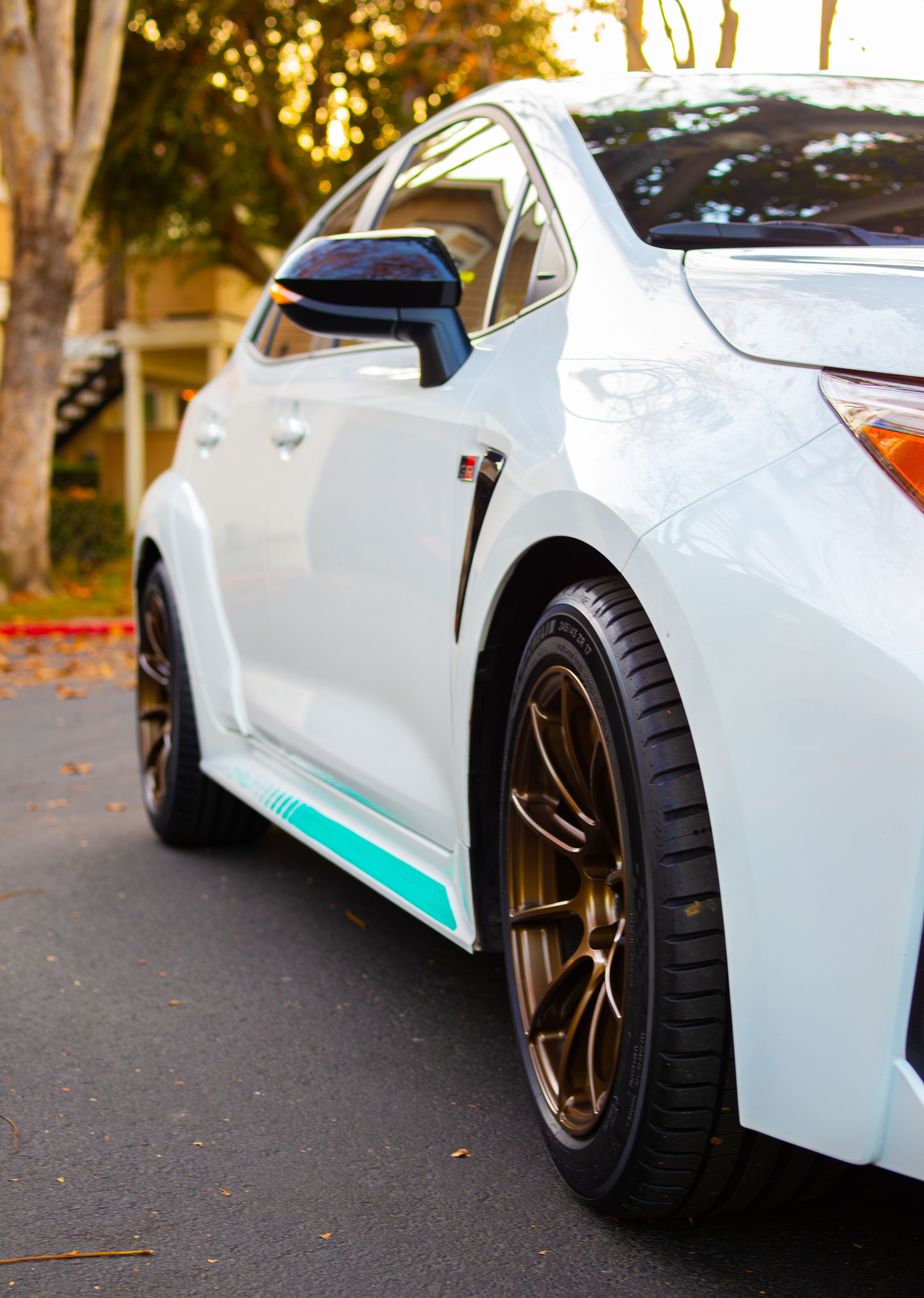 White Toyota GR Corolla with 17" SM-10RS Apex wheels in Satin Bronze